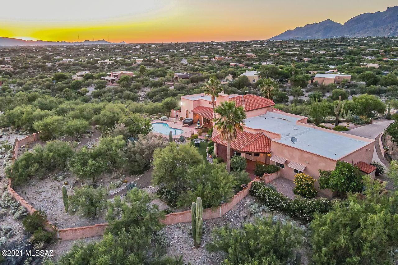 Panoramic Views of the city, sunsets, and mountains from this rare listing in this sensational foothill's neighborhood located on a cul-de-sac lot nestled next to lush desert common area and ready for your move in.  It is freshly painted inside & outside, has high ceilings and is surrounded by a new adobe walls. Many upgrades and improvements to home and landscaping. Appreciate the inspiring views from the new Anderson windows & screens.    
New distressed engineered hickory wood floors. All new appliances including a gas range & vent. The backyard has grapefruit, tangelo, lemon/orange hybrid trees and a refreshing replastered pool with new tiles & cool deck paint.  Workshop space in garage.   Relaxing portable spa conveys. Many nearby amenities include Whole Foods, parks, Basis, TMC, restaurants and trails.