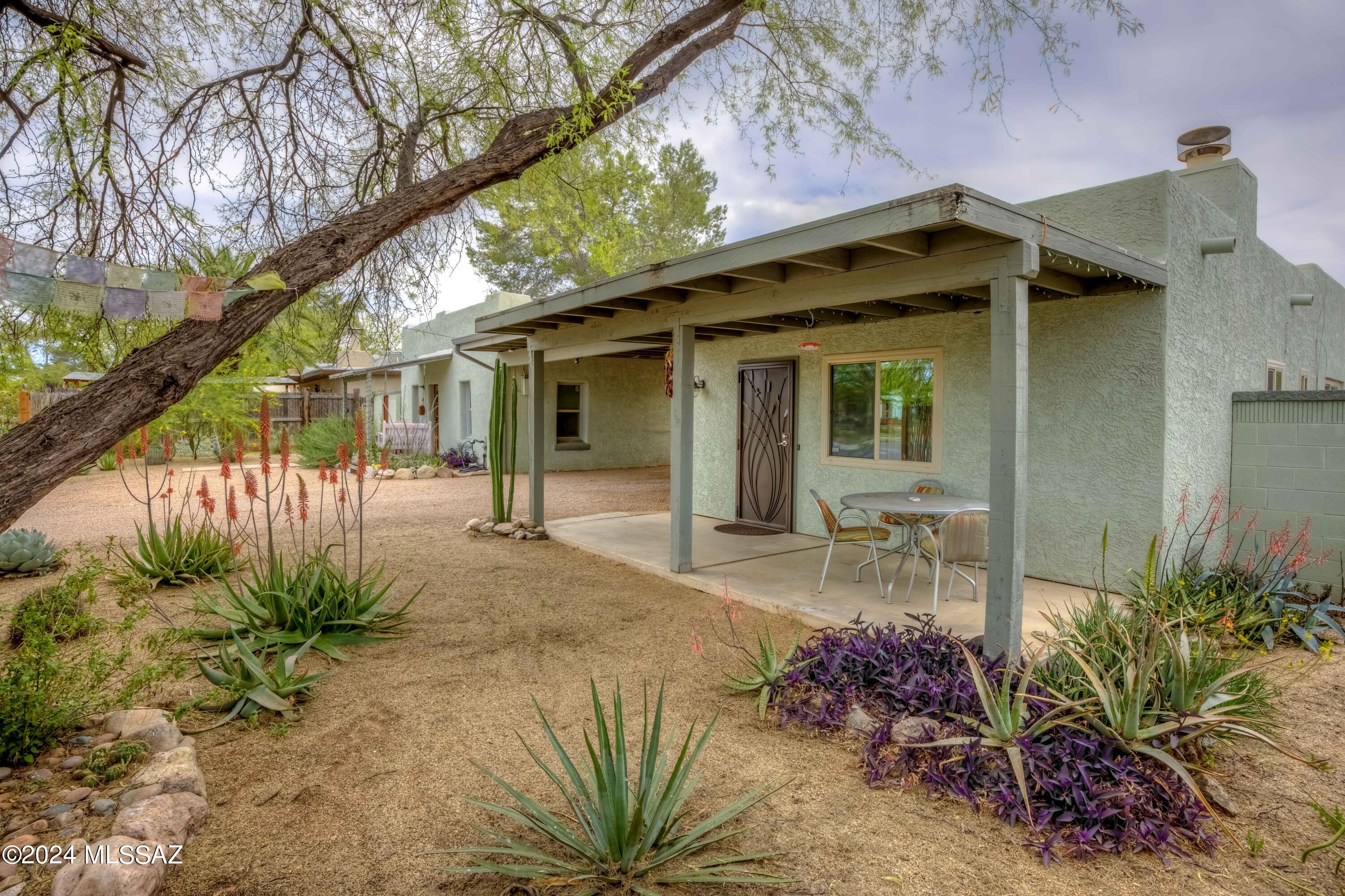 Beautifully remodeled 2 1-1/2 house in central Tucson with charming 2-1 mud adobe guest house! Main house remodeled from top to bottom inside with all new kitchen appliances and wood burning fireplace in living room! Both structures make good use of the lot and have separate fenced back yards with covered patios, guest house has brand new chiminea fireplace in backyard. Off street parking with carport connecting both units.