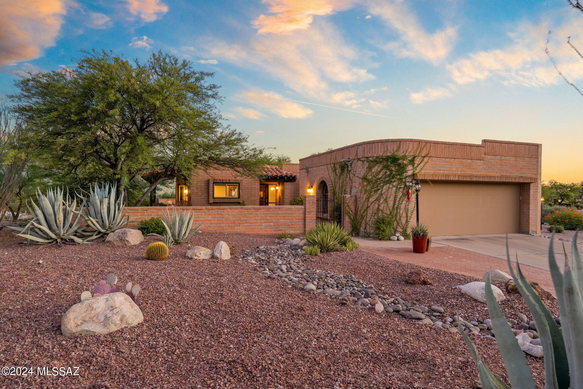 Views, location and more views! Beautiful home in the highly sought-after Fairfield community near Sabino & Ventana Canyon. This beautifully updated, well-maintained home features modern tile flooring & an upgraded kitchen with updated dovetailed soft close cabinetry with pullouts, granite & stainless appliances. The open dining/ living room space offers soaring ceilings and a cozy gas fireplace, flanked by sliding doors that frame breathtaking city light & sunset views Granite wet bar. The primary bathroom boasts a large tiled shower, built-in cabinets & dual vanity with granite. The very private back patio is perfect for relaxation & entertaining featuring a covered area & open brick paver patio + raised patio that enhances the amazing views! Mature landscaping invites lots of bird life Covered side patio with sliding door from the kitchen is perfect for your BBQ grill. All outdoor pots and patio furniture conveys. Space between the neighbors to the east of that patio enhances your privacy and tranquility and also takes in the Rincon Mountain views. Front courtyard patio and the kitchen window take in the beautiful Catalina Mountain Views to the North as well as open green space across the street.  Driveway has additional brick paver parking space for a third car.  Enjoy maintenance-free living in a resort-like setting, complete with two pools, spas, & tennis/ pickle-ball courts. The location is  in between both community pools with the heated pool to the east. Location is minutes to shopping, dining, golf and art galleries. Experience the perfect blend of luxury, comfort, and convenience in this exceptional property. Don't miss the opportunity to own this beautiful home in one of Tucson's most desirable neighborhoods. Roof recently coated. Termite warranty. Newer garage door opener. Home used only in the winter months and exceptionally cared for!!