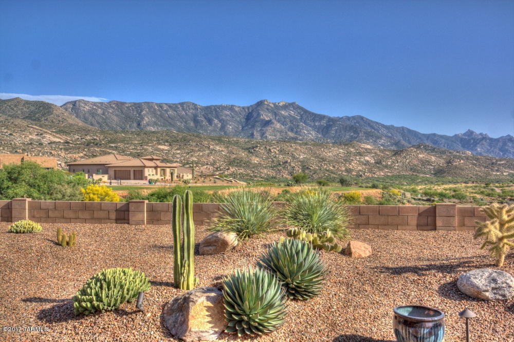 One of the very best view lots in The Preserve at SaddleBrooke. The ultimate in Southwest living. Unobstructed
views of the Catalina mountains and the golf course. Modern Santa Fe style home is casual yet offers high end
appointments for the discerning buyer. This Canyon model has an open great room plan with a wall of windows
to enjoy the spectacular views. A custom media wall includes the flat screen TV, gas fireplace and lighted niches.
A chef's kitchen features craftsman style cabinets, granite counters with glass tile back splash and high end
appliances. The Southwest theme interior coordinates all flooring,counters,wall colors, window
treatments and fixtures in warm desert hues. Outdoor living space includes automatic solar screens at the patio, Kiva fireplace and in ground spa The expanded patio offers a spectacular view across open desert space, to the golf course and the Catalina mountain range.
This popular floor plan includes a separate media room with surround sound and an office with custom built-in desk, cabinets and wall bookcase.
Build Upgrades:
        - Tile Floor upgrade throughout
        - Carpet and carpet pad upgrade (both bedrooms)
        - Great Room gas fireplace
        - Great Room wall design with mantle, alcoves and accent lighting
        - Granite counter tops in Kitchen and Laundry area
        - Cabinet upgrades in Kitchen
        - Glass tile back splash upgrade in Kitchen
        - Accent lighting for cabinets in Kitchen
        - Kitchen sink upgrade
        - Kitchen appliance upgrades:
                Bosch gas cook top
                Refrigerator - built in with matching cabinet finish
                GE Oven and Microwave
                Fisher Paykel Dishwasher - drawer style
        - Audio/Video system:
                TV wall mount connections in Great Room, MBR, and Media Rm
                Ceiling speakers in Great Room and MBR
                Surround sound speakers in Media Room
        - Guest Bed Room - Added 4 ft. to length
        - Bathroom fixtures upgraded in all bathrooms
        - Ceiling fans in Great Room and bedrooms
        - Garage floor epoxy coating
        - Garage storage cabinets and work bench
        - Garage door side mounted motor units
        - Patio tile upgrade


After Purchase:
        - Custom cabinets in Study with accent lighting
        - Hunter Douglas window treatments throughout
        - Expanded patios in front and back
        - Kiva fireplace and wall on back patio
        - In-ground spa off back patio
        - Patio ceiling fan
        - Screens to enclose back patio - powered remotely
        - Side walls with gate for each side of house
        - Entry gate and wall enclosing front patio
        - Extensive landscaping
        - Garage shelving - Monkey Bar
        - Epoxy coated driveway