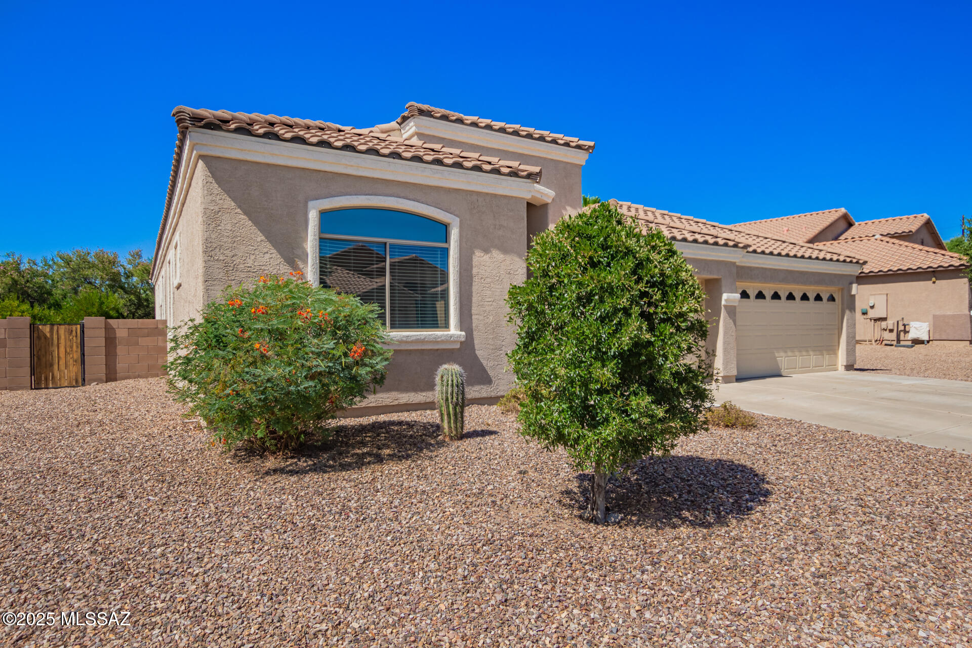 Welcome to your dream home at 11056 W Caracara drive, a stunning single-story home in Marana's desirable Gladden Farms cmty. This Modern residence blends comfort and desert charm, perfect for families or professionals seeking a serene lifestyle. Spanning 2,338 sq. ft., this home offers 4 bedrooms and 2 full bathrooms. The open concept living area features high ceilings, natural light, and sleek finishes, ideal for gatherings. The gourmet kitchen boasts granite counters, large island, perfect for cooking and entertaining. The primary suite is a tranquil retreat with dual vanities, soaking tub, separate shower, and large walk-in closet. Other bedrooms are versatile for guests or office. A 3-car garage adds convenience. Home also includes built in water filtration device and epoxy garage flo