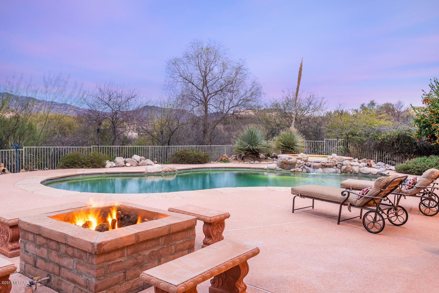 Exquisite equestrian estate tucked in custom community w/state of the art 40x60 barn & 65x135 arena. Courtyard w/blooming desert flora sets the stage for this custom 3,113sf, 4BR/3BA home w/upgrades galore. Gourmet kitchen is the heart of the home joining large great room w/walls of windows to gaze at panoramic Mountain views. Guest quarters w/separate entry. Both casual & formal areas offer a variety of room functions. Spacious master suite w/bath retreat joined by 2 way fireplace. Enjoy the best of AZ outdoor living w/oasis style pool/spa & tranquil H20 feature w/picturesque mountain backdrop. 1,200sf covered patio outdoor kitchen, fire pit, herb garden & professional landscaping, fruit trees, soft water loop, surround sound pre-wired, wood interior doors, 18x18 tile in all main areas.