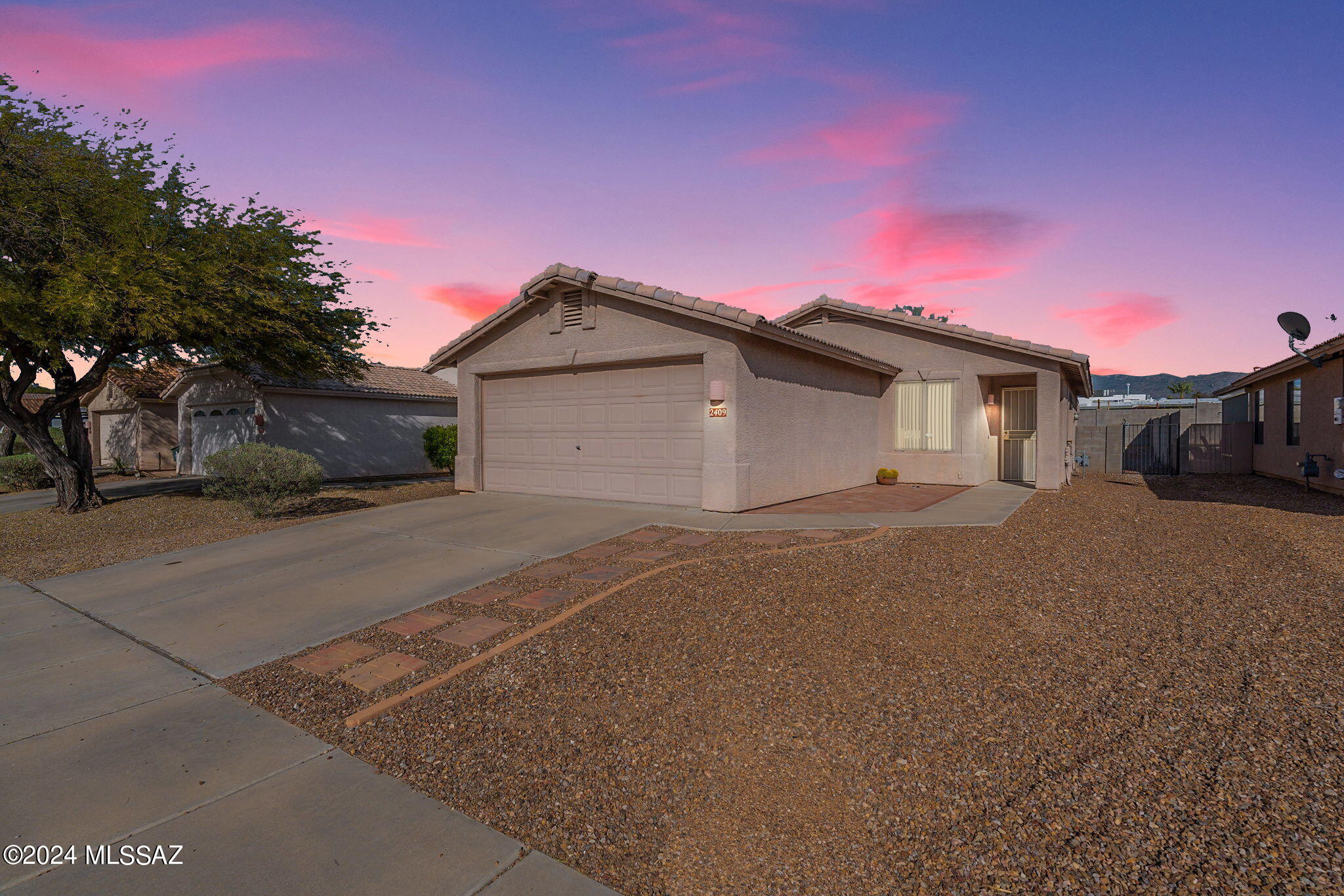 Affordable opportunity for move in ready 1,136 SqFt 3 bed/2 full bath modern contemporary 1999 built home with attached 418 SqFt post tension garage with new garage door motor, springs and coils, located in desirable Arroyo Ridge community in East Tucson. Featuring: E/W orientation for daily mountain views, low maintenance concrete tile roof, concrete driveway and sidewalks, ample off street parking, low maintenance front yard and metal security door. Inside enjoy painted textured ceilings (no popcorn), PEX plumbing (no polybutylene), energy efficient double pane windows, custom blinds, ceiling fans, wired for alarm, new Lennox gas HVAC 2021, smart NEST digital thermostat, custom shelving, internal laundry room w/exhaust fan, washer & dryer included, new carpet in the two guest bedrooms full guest bathroom with shower/bathtub, large primary bedroom with private ensuite updated full bathroom with tiled walk-in shower and new toilet. Open concept kitchen adjacent to dining area with tiled floor, hickory cabinets, electric oven, built in microwave, dishwasher and refrigerator convey. Enjoy Tucson sunsets from your private backyard covered patio with hot tub on separate circuit breaker, brick pavers, always green artificial grass, raised flower garden, side gate, sewer clean out, 200 AMP electrical panel and mountain views surrounded by 6ft privacy block walls. 
Reasonable $19.33 monthly HOA dues allow rentals making this a great solution for home buyers and investors alike! Convenient East Tucson location close to shopping, groceries and short drive to Northwest Medical, Davis-Monthan Air Force Base and Raytheon. Call to make your appointment to view this beautiful home today!