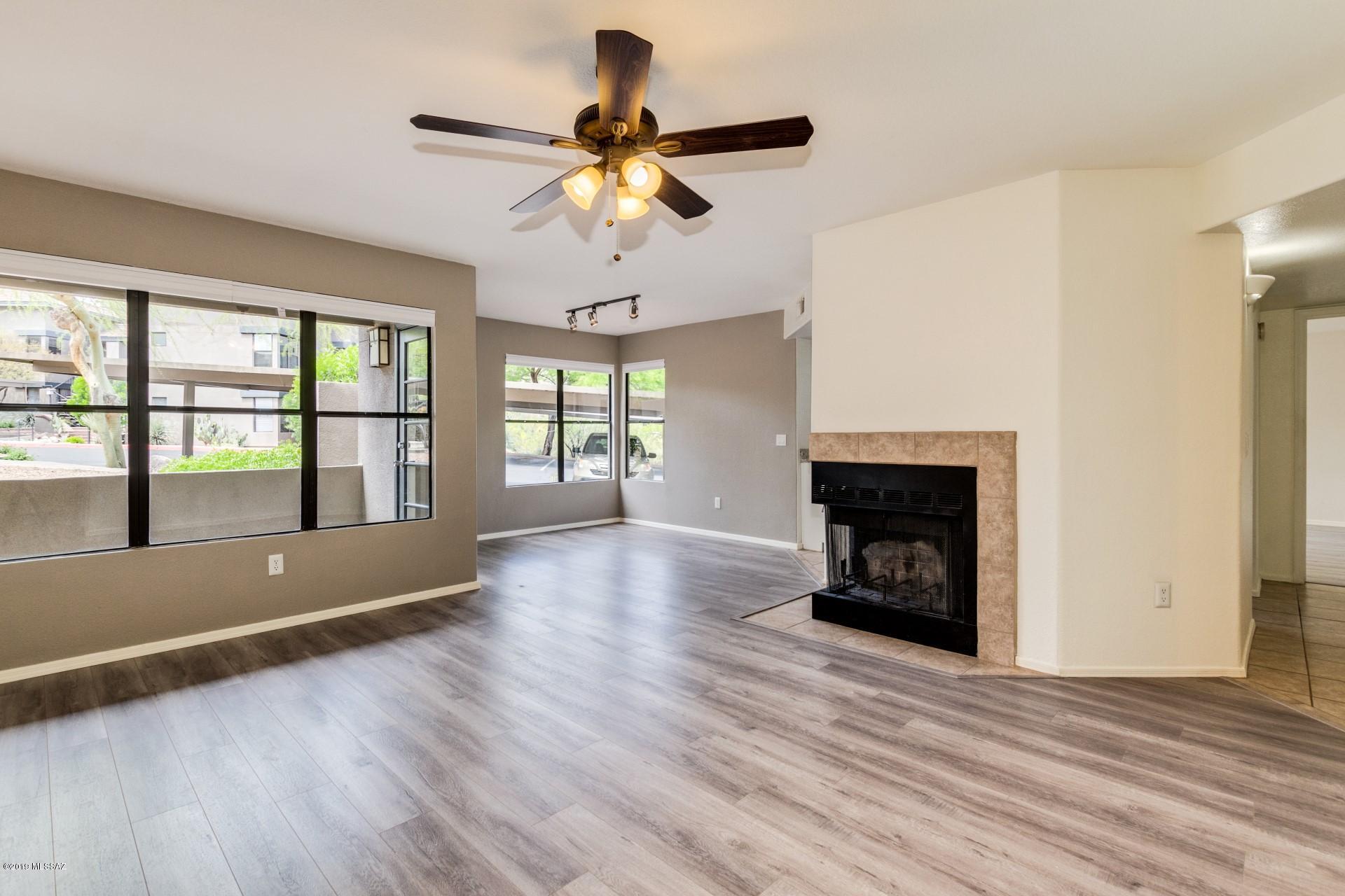 Stunning condo in The Greens at Ventana Canyon! Gorgeous gray flooring, cozy wood burning fireplace and modern color palette. The kitchen features granite countertops, stark white cabinetry, tile flooring and a large SS sink. The spacious bedrooms offer plenty of room for sleep, study and storage. Find in unit laundry area in the hallway closet. Private balcony with mountain views. The Greens offers 3 luxury pools/ hot tubs, fitness center and more!HOA covers water, sewer, trash, pest and exterior maintenance. Range Price*