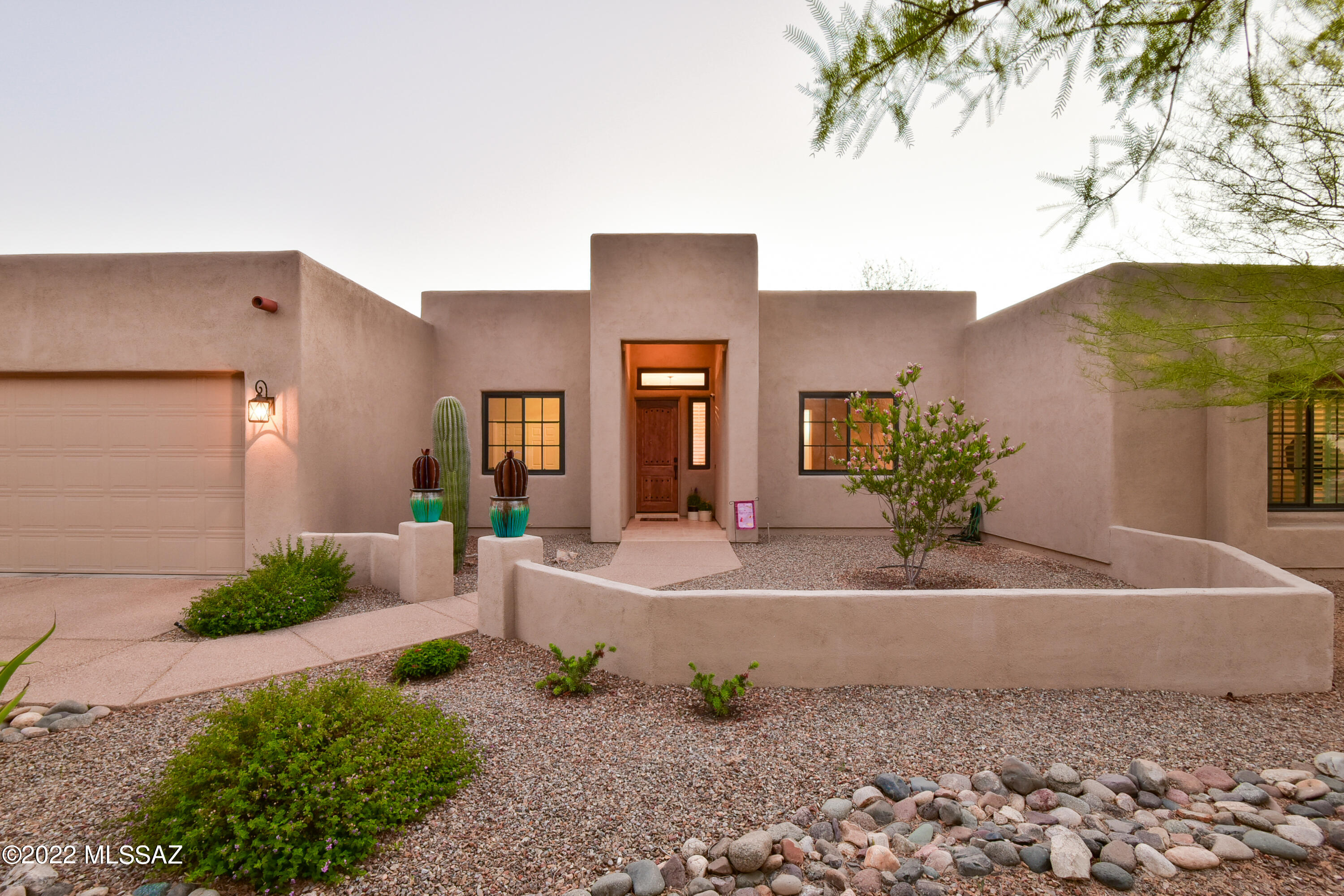 Seller to entertain/counter offers between $800-850k. Perfectly situated on a large half-acre lot backing to desert green space, this backyard oasis will have you feeling like you are on vacation year-round! Enjoy sunset views while relaxing poolside or gather with friends around the charming outdoor fireplace. A raised outdoor kitchen/dining area is the perfect spot for dining al fresco, surrounded by lush, natural landscaping and easy-care turf for year-round green. Inside, attention to detail and upgrades carry throughout the home, including plantation shutters, attractive tile flooring, water softener, and new windows and sliders. Gorgeous hickory cabinets highlight the bright, open kitchen with counter-height island seating, sleek granite counters, gas cooktop, and wall ovens. Bonus work center with built-in desk and storage will help keep your household running smoothly! Light-filled main living area features clever built-ins and a graceful gas fireplace. Coffered ceilings in the formal dining area create a grand focal point upon entry, with an open den and bonus office/bedroom flanking the open foyer. Escape to your personal sanctuary inside the owner's suite, where an elegant ensuite bath with extended double vanity, stunning tiled walk-in shower, and inviting freestanding tub awaits you. Two additional bedrooms share a convenient Jack-and-Jill bath, a roomy laundry with bonus storage, and three car garage offers plenty of extra space for storage or hobbies.