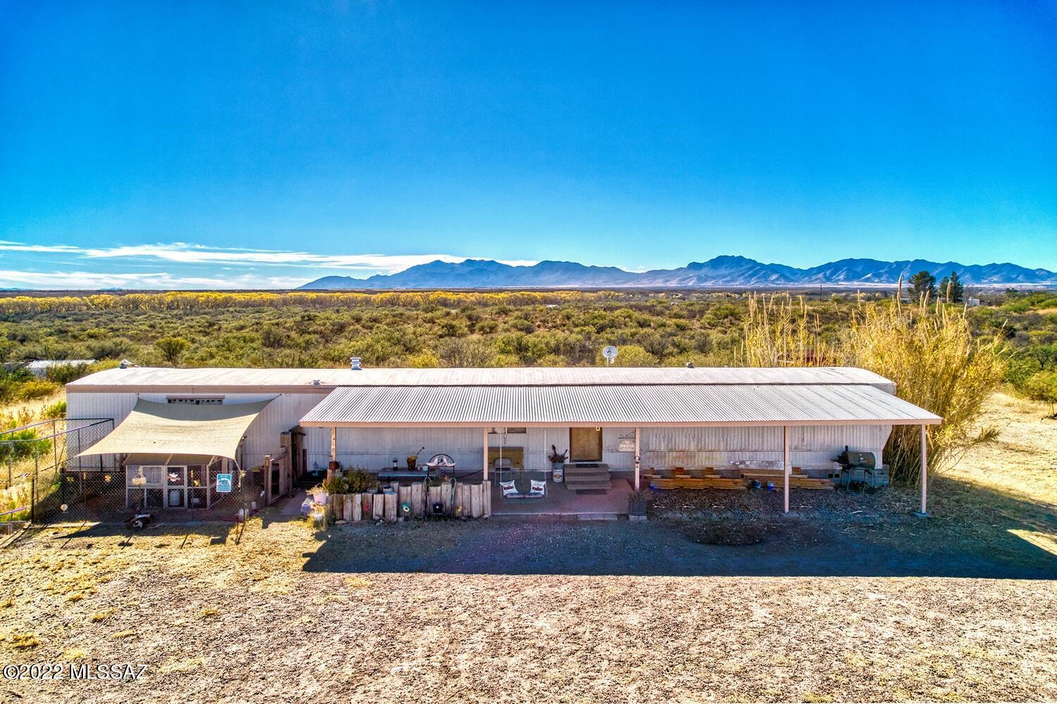 Enjoy spectacular sunsets and nature views with 360-degree mountain landscapes as your backdrop. Many newer features and upgrades in this 1064 sq ft single-wide manufactured home! This well-maintained open concept 3 bdrm, 2 bath home is move-in ready! Cool central A/C replaced in 2015, appliances replaced in 2020/2021, cabinetry upgrades in 2015! Enjoy privacy and open spaces in your own fully fenced 4.45 acres, ready for toys, horses or other uses! Full RV hook-up on the property. New circuit breaker box for pump on your own private well. 2nd Breaker Box and pole installed on the property and ready for future use. Right off a paved road for easy access! Enjoy the country, while still close to shopping, Ft Huachuca and more. Lots of possibilities! This one won't last!