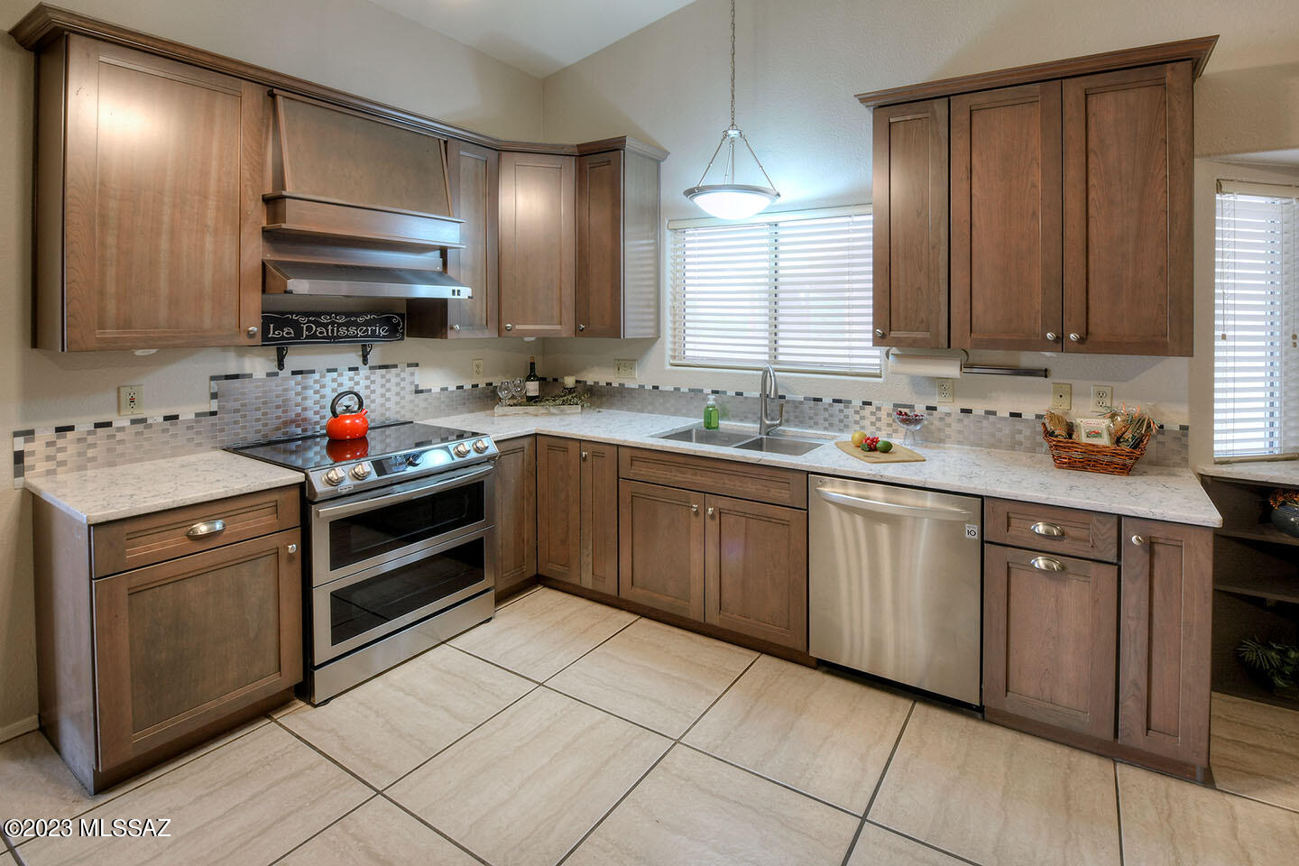 Nestled in a tranquil neighborhood with no HOA, this spacious 4 bedroom, 2 bath home has an exquisite remodeled culinary kitchen. This stunning kitchen has soft close cabinets, gorgeous granite countertops, SS appliances, pull out shelves & a movable kitchen island that provides the flexibility to accommodate your ever-changing needs. Front courtyard has 2 gates with a custom front door. As you enter the house, you'll be greeted by a spacious open-concept with 24-inch tile floors for easy maintenance. This home has lots of natural light, large backyard with block walls, shed & covered patio.  Primary bed/bath has large walk-in closet, dual vanities, garden tub/shower & storage cabinets. HVAC replaced in 2016, sunscreens on most windows and a great floorplan for only $369,000. Purple Heart Park is nearby: https://www.tucsonaz.gov/Departments/Parks-and-Recreation/Parks/Purple-Heart-Park