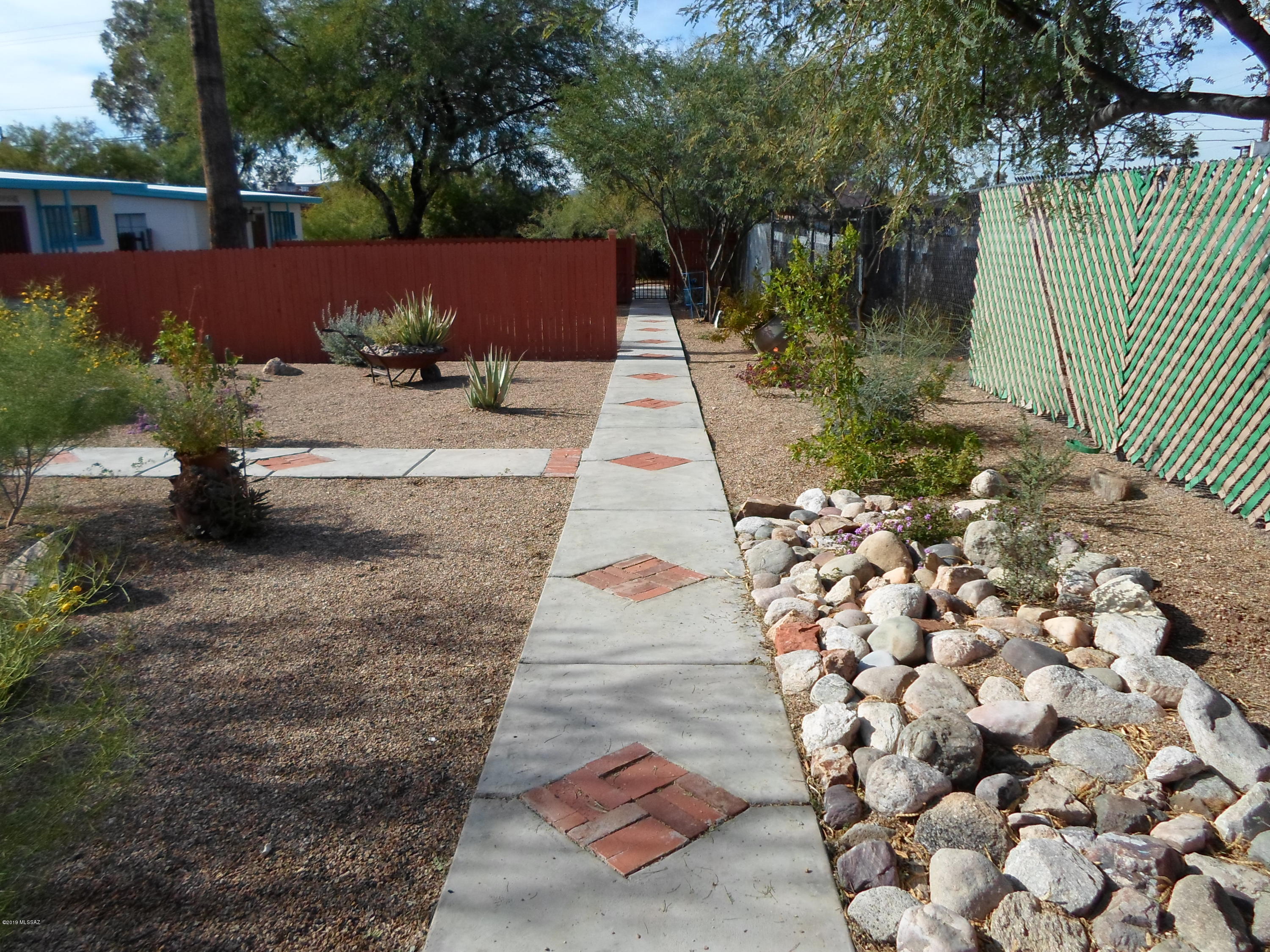 Beautiful stand alone Casita with its own private front and back yards and covered back patio. Only three Casitas in this complex. Very quiet and private with secure gated access and off street parking. Completely remodeled unit with plank and bean ceilings throughout, stained concrete flooring throughout, modern kitchen with stainless appliances, builtin microwave, standup shower, builtin bookshelves, walk in closet, lots of storage cabinets, window treatments, air conditioning, private washer and dryer. Owner managed. You will love living here!