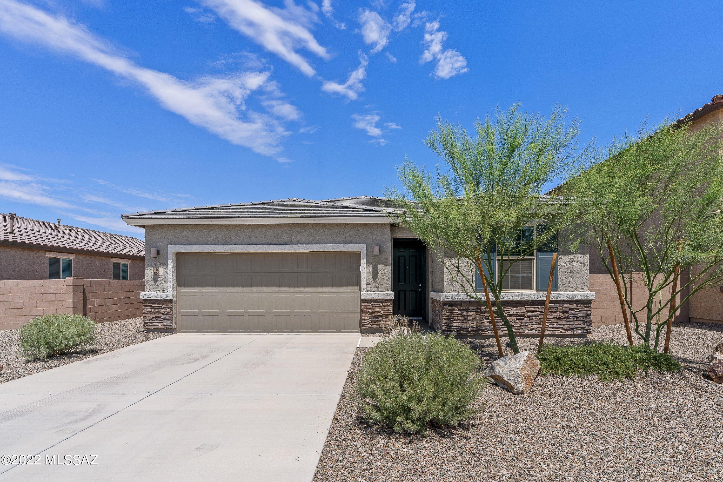 This 3-bedroom 2-bath home in Gladden Farms was built in 2021 and looks and feels brand new. Wood like cermaic tile through out main areas and carpet in bedrooms. Open split floor plan design with 9-foot ceilings provides a real sense of space. Twelve-foot-wide sliding door looks out on backyard and green space. Completely enclosed yard with no neighbors behind you. Appliances are all like new. Refrigerator, dishwasher, microwave, gas range/oven, washer and dryer all included. Central air conditioning, plus ceiling fans in all 3 bedrooms. Large primary suite with double vanity and large walk-in closet. Two-car garage with extra depth for storage or work area. North facing covered patio. Low maintenance desert landscaping. Unless otherwise requested by tenant put down to Blue Fox is an Equal Opportunity Housing Provider. We are also licensed Realtors