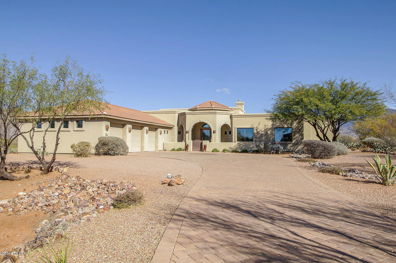 Must see this Gorgeous 5 BR,3.5 BA custom built home on over 2 acres! Located in the highly desirable gated community,Coyote Creek! Fantastic upgraded finishes abound. Travertine tile, ceiling speakers throughout, gorgeous etched glass front door, recessed ceilings, and plantation shutters! The kitchen is a chef's dream with beautiful granite counters, double ovens, gas range, a prep sink, and  stainless appliances. Separate formal dining room makes dinner parties a delight along with a wine closet near by. The spacious master retreat boasts a fireplace and tons of windows to gaze upon the spectacular Rincon Mountains. The back oasis is perfect for entertaining with a beautiful pool w/water fall, fire pit,outdoor kitchen, and unobstructed views! Located in the Vail School District. The Coyote Creek Neighborhood offers some incredible ammeneties and outdoor activities at the Recreation center and they even have their own equestrian center! Visit the community website for more details and pictures. http://www.coyotecreekhomeowners.org