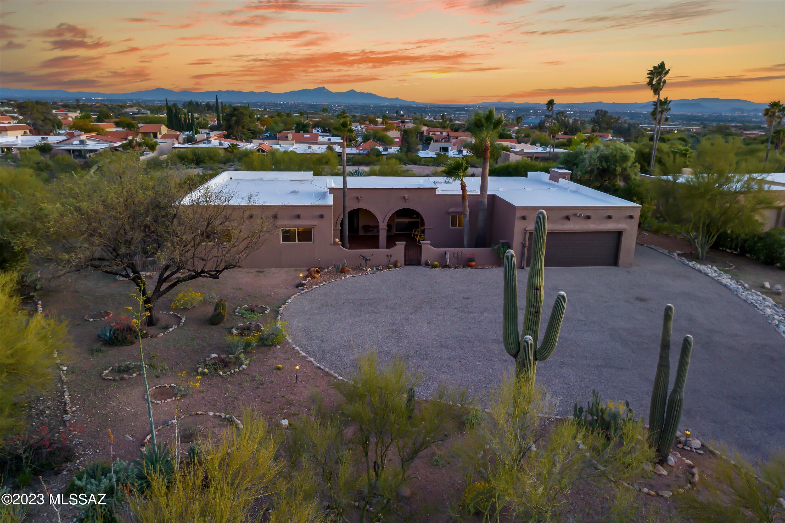 Be the 'King of the Hill' on this elevated lot that is unlike any other in the neighborhood! Privacy abounds being set back from the road & with a large wash just behind, very private...you don't even notice your neighbors are there! Up close views of the Catalina Mountains & sweeping city views include downtown and A Mountain. Masonry stucco construction. Spacious layout & the great room floorplan is perfect for entertaining! So many upgrades including, but not limited to a newly refinished pool, fresh painted exterior & new dual pane windows! See upgrades list! No carpet in this home. Large covered patios front & back. Lots of closets & lots of parking! Workshop/storage in garage. District 16 schools (walk to Catalina Foothills High). Close to great shopping & some of the best dining.