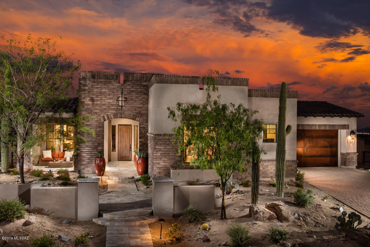 FINAL OPPORTUNITY!!! The last highly upgraded Toll Brothers Model home is nestled within the heart of the Dove Mountain master planned community, where resort style living and the High Sonoran Desert reside in harmony. Completely custom designed, this incomparable residence is located behind private gates and surrounded by mature desert landscape. This 3400 square foot residence, 4 bedrooms, 3.5 bathrooms (includes guest casita) with welcoming tones and textures adding a sense of warmth to the home. The light-filled foyer invites you to enter the sophisticated study and formal dining room as you move into the kitchen and great room while enjoying the pool view from the covered patio.