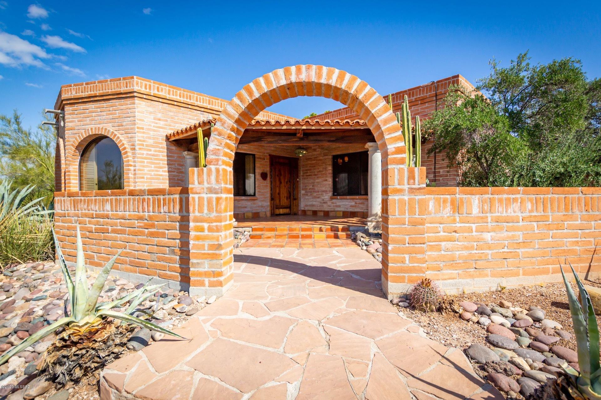 Views! Views! Views! ONE OF A KIND! Awesome Burnt Adobe Hacienda on gorgeous view lot in Catalina Foothills. Spectacular Great Room w/ soaring ceilings, custom wrought iron, stunning fireplace. Cozy Library/Den w/Custom concrete floors & huge city views. Gorgeous Master Suite w/ Stone pedestal sinks, Travertine. Amazing Guest House w/ flagstone , a separate kitchen & bath. Windows w/ forever mountain views, rooftop deck. Resort-like grounds w/pool, secluded patios, outdoor BBQ & fireplace. A GEM!!