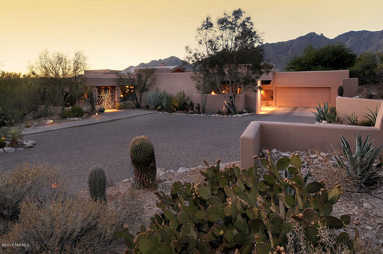 Sellers will accept or counter offers $1,000,000-$1,050,000. Outstanding 4 bedroom + den Tyson Murphey high on a hill on a 1.07 acre lot at the end of a cul-de-sac in the foothills with sweeping Catalina Mountain views. Gracefully remodeled with charm, beams, warmth and views from all north facing rooms, this 4543 sqft+ home offers custom designed, inviting patio entry, living room and kitchen with decorative beams and 14' ceiling and open flowing floor plan with abundant natural light. Gorgeous gourmet kitchen features slate countertops, stainless steel designer appliances, custom bronze hardware, maple cabinetry and glass tile backsplash. Gracious master suite with unobstructed mountain views, two offices, sun room, custom unique lighting in dining room,