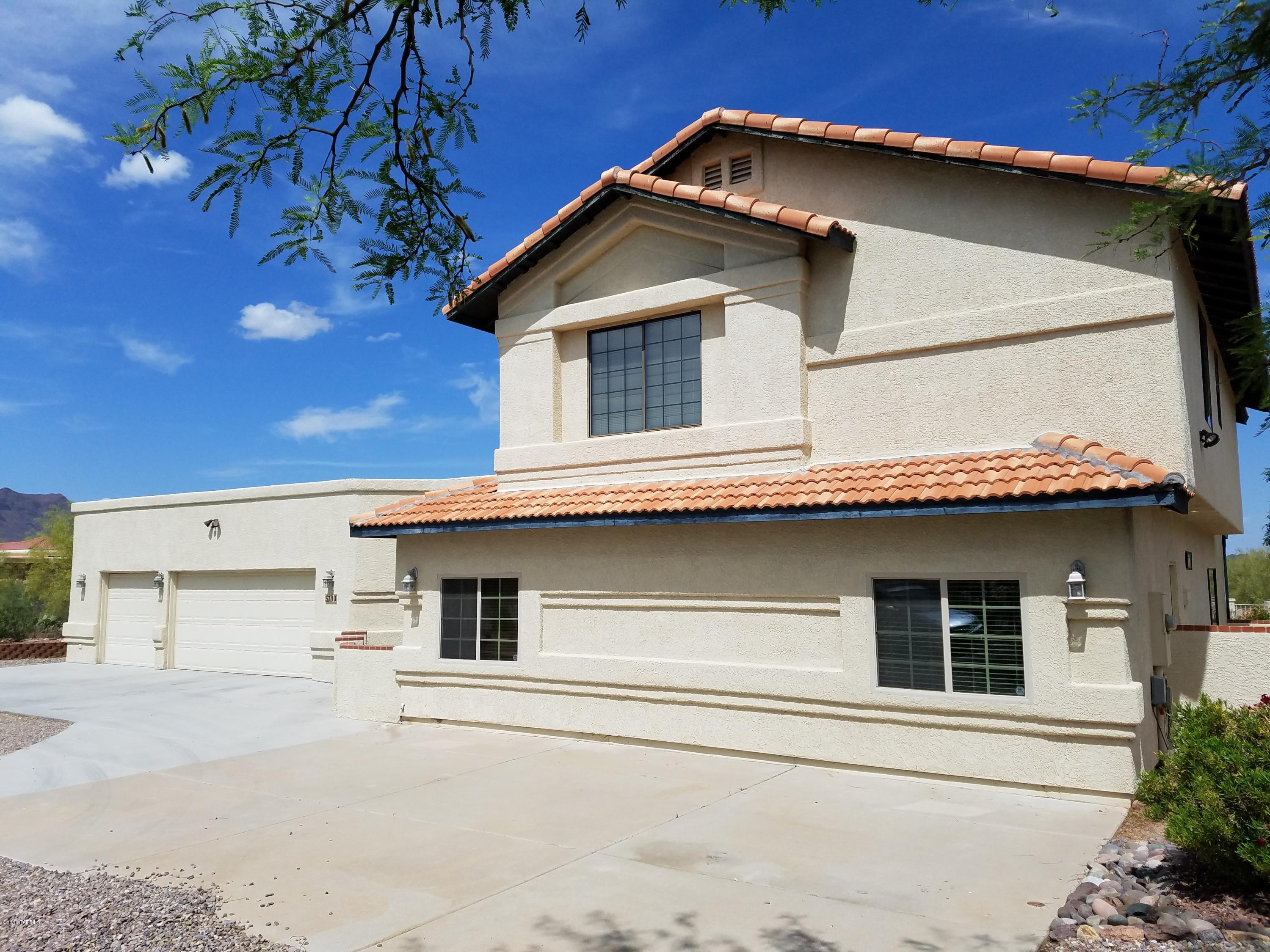 Beautiful 2 story Southwest style home on very private 1 ac lot. Enjoy gorgeous views of 3 mtn ranges, lush desert, city views & spectacular sunsets! This  beauty features ceramic tile floors downstairs. Large family room adjacent to kitchen w/built-in brick entertainment center. Kitchen has new dishwasher, double oven/range, oak cabinets with pull-outs, breakfast bar & breakfast nook! Spacious living/dining room. Two lg bedrooms downstairs (part of 2010 remodel) perfect for guests! Three large bedrooms upstairs,all with walk-in closets! Two separate enclosed backyard areas, one w/playground, storage building,fruit trees, double gate. Extended 3 car garage built 2010 w/shelving,extended concrete area in front for additional parking. Gorgeous rose garden & flagstone patio area
