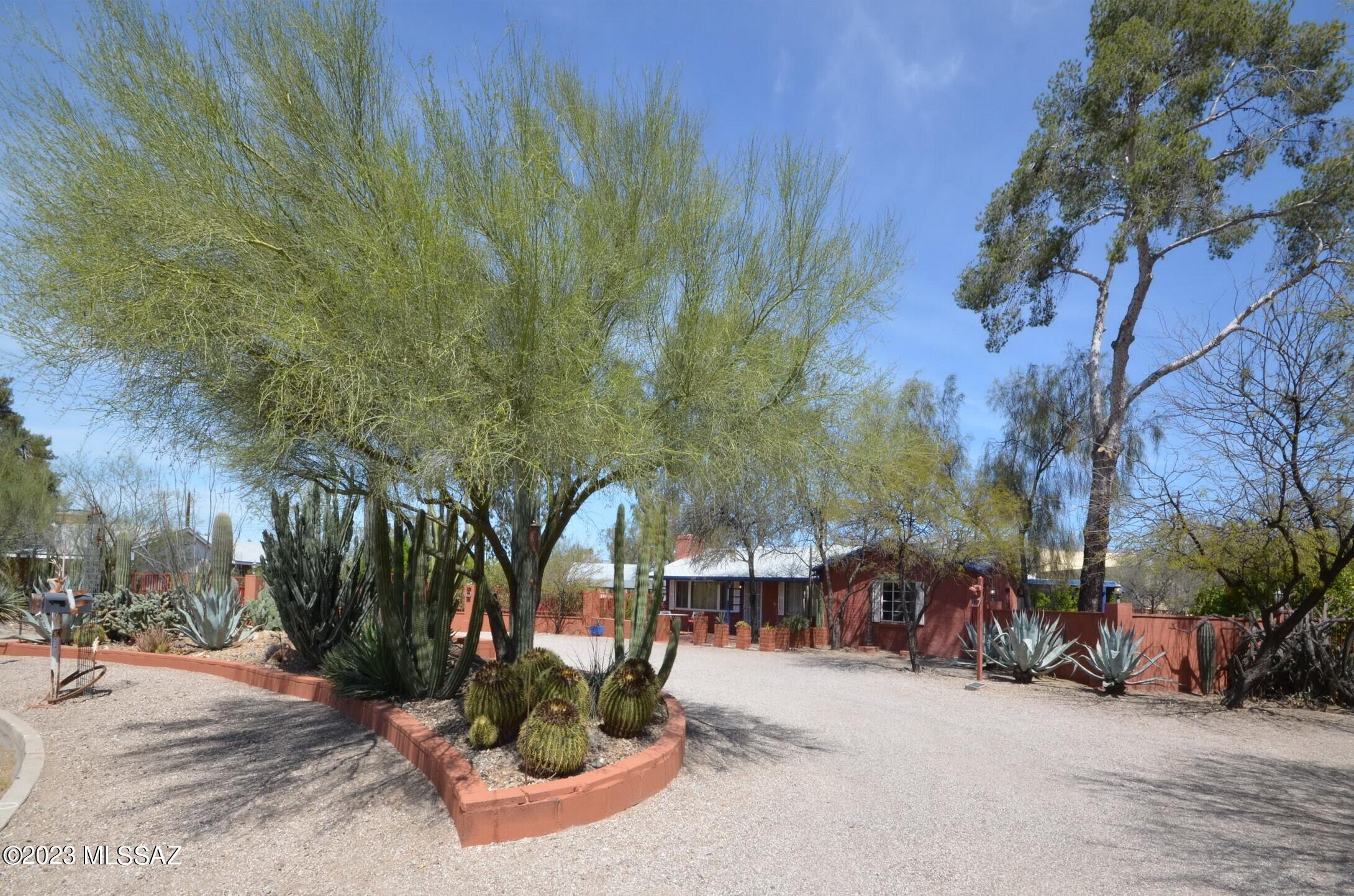 PRICED TO SELL! Don't miss out on this rare opportunity to own a large home with a large guest house, a 16x50 ft pool in a fully gated .9 acre park-like setting in highly coveted Catalina Vista!  The main home is 2,669 sq ft, has a 4 bedroom split floor plan, 3 full bathrooms, an open great room as well as a formal living room with fireplace. The spacious kitchen has granite counters, lots of storage and a sizeable walk-in pantry. The main home has french doors leading to a variety of exterior entertaining spaces. In addition, there is a 690 sq ft guest house with its own entrance, carport, covered patio as well as a private walled patio and storage sheds. The large guest house boasts a full kitchen, bathroom, walk-in closet and its own washer and dryer. The property has a variety of mature citrus trees throughout. The large pool is gated, perfect for laps and lounging. Leased solar panels translate to lower electric bills, Next to U of A, Banner Hospital, shopping and restaurant row, this property has wide appeal as it's perfect for multi-generational living, or represents an opportunity to have rental income while you live in one and rent the other! Hurry, this one won't last!