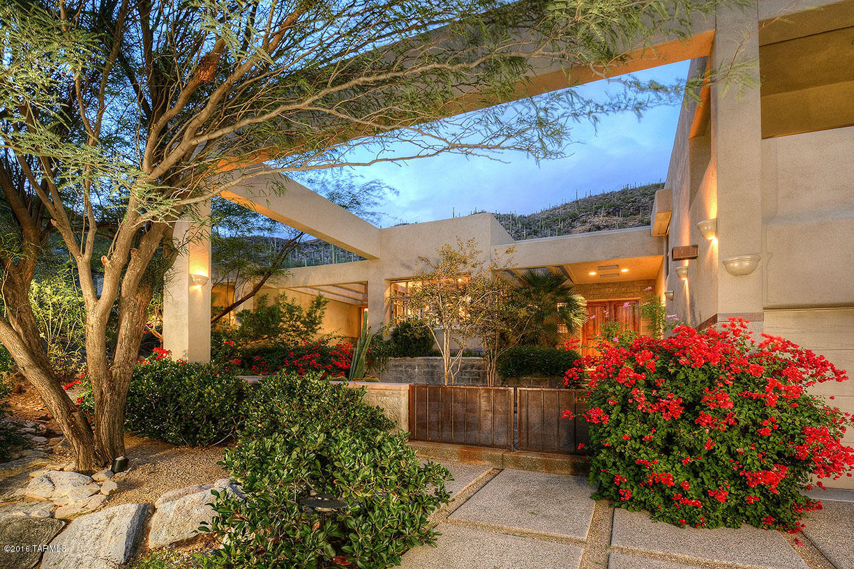 Fabulous contemporary custom home with guest house sitting on a very private lot up in Ventana Mountain Estates with stunning mountain and city light vistas. Beautiful high end finishes include mesquite entry door, scored concrete and Manganese saltillo floors, high ceilings & floor to ceiling glass windows. Interior bridge walkway over stream into the master suite and yoga studio. Step into the guest house, art studio or Pilates room which feels like you are in the middle of the high Sonoran desert. Enjoy the backyard pool, spa, waterfall and outdoor shower.