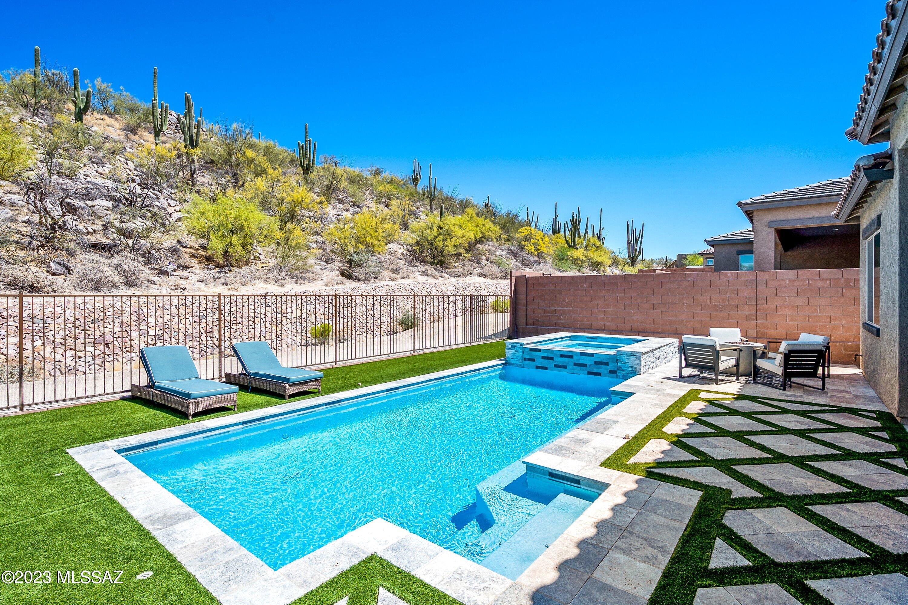 Enjoy the breathtaking views of HoneyBee Canyon from the comfort of your home! Sitting on a premium lot in the gated Alterra at Vistoso Trails Community in Oro Valley. Enter this beautiful home from the courtyard and foyer, which leads you right into the open concept living room, kitchen, and dining area. Enjoy entertaining in your resort style backyard featuring a covered patio, beautiful pool/spa, and synthetic lawn.

The owner's suite is conveniently located in the back end of the home, separate from the den, and 2nd and 3rd bedrooms. This home has additional upgrades including a contemporary fireplace with built-in shelving, gourmet kitchen with upgraded cabinets and quartz countertops, the master bathroom boasts a walk-in shower and garden tub, extended garage, and so much more!