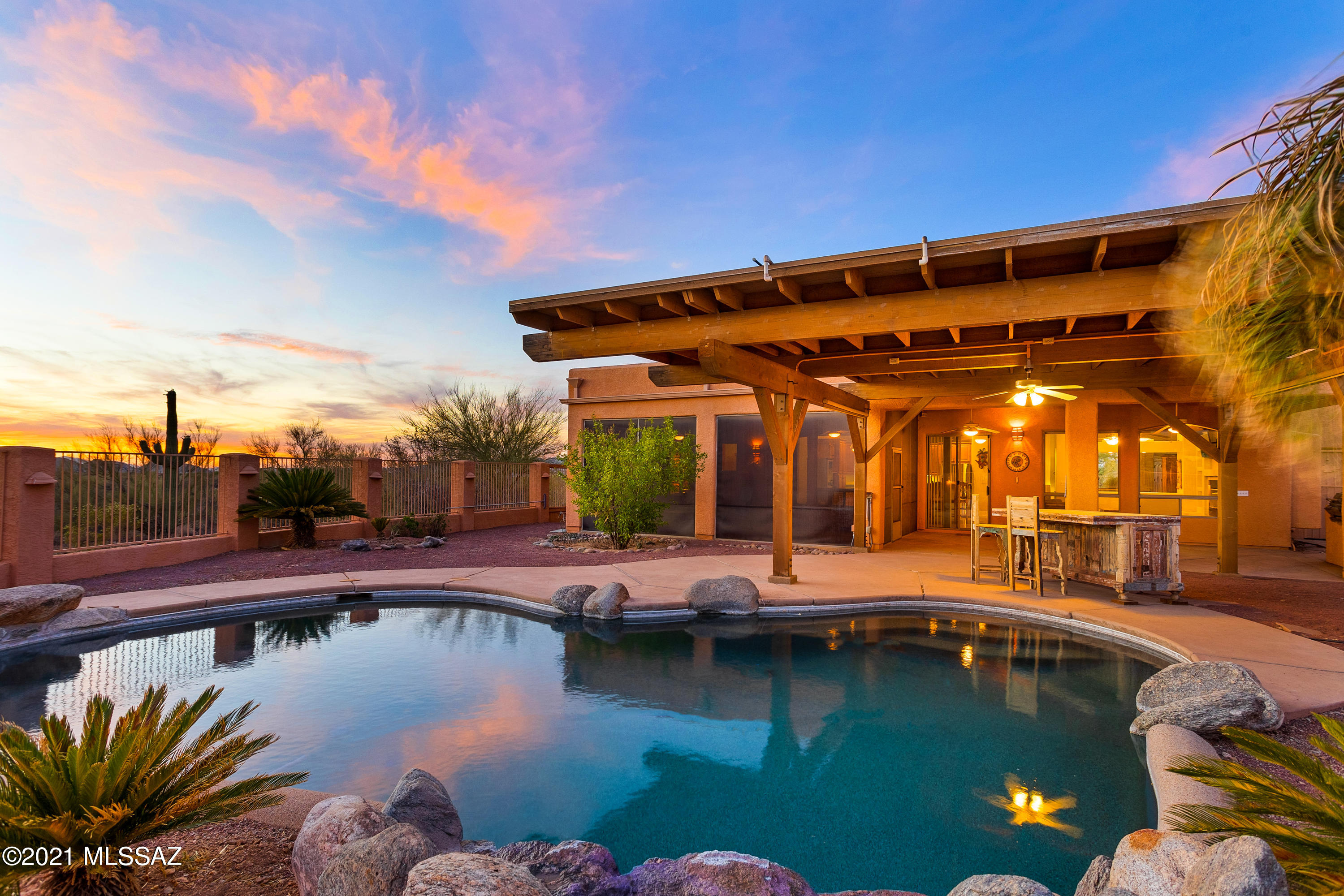 An amazing PRIVATE Tucson Mountain Foothills custom home with 6.8 acres & subdividable! This INCREDIBLY flexible floorplan boasts 3545 SF with 4 bedrooms, 4 baths including an amazing guest quarters. Open floorplan with lots & lots of entertaining spaces. The kitchen is open to the living spaces & the amazing back yard with the gorgeous Pebble Tec pool, built in bbq & screened in patio. There are amazing views from every room & every corner of the property. Concrete floors throughout & tons of storage. The guest quarters could serve as an AirBnB, office, studio, etc.  There are simply so many options! FOUR car garage plus the HUGE RV Garage which has all the bells & whistles you could desire. SR Zoning allows for a split with the buyer to research.Close to so very much yet you feel remote.