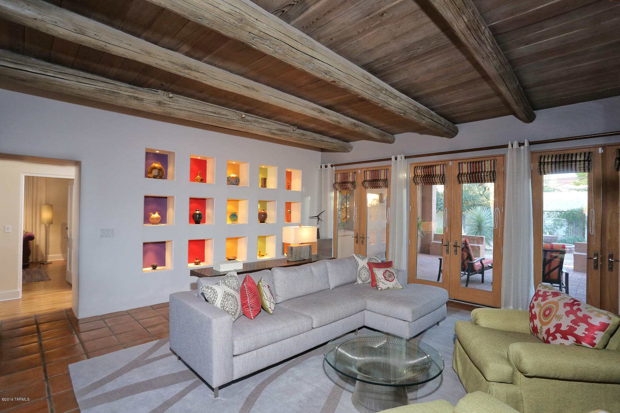 Stunning, modern, interior design by Rochelle Rubin--3764 sqft in a private, walled, oasis--blocks to the Arizona Inn & Medical Center, 1/2 mile to the U of A & street car. 11-12'high, wood, beamed ceilings w/ 2 fireplaces. Exquisitely remodeled & expanded from the original 1935 home. MBR Suite addition (approx. 600 sqft)--luxurious bath (marble tile floors, large separate shower, stunning claw foot tub, radiant heated floor. Gourmet kitchen (Corian counters, 4' commercial stove, wine cooler, mahogany top bar top, under counter freezer drawers, etc.). 5 sets of Pella French doors open to a new ramada surrounded by a beautiful, professionally designed landscape & center fountain.  Great home for entertaining or reading by the library fireplace.  Floor plan under photos & virtual tour.