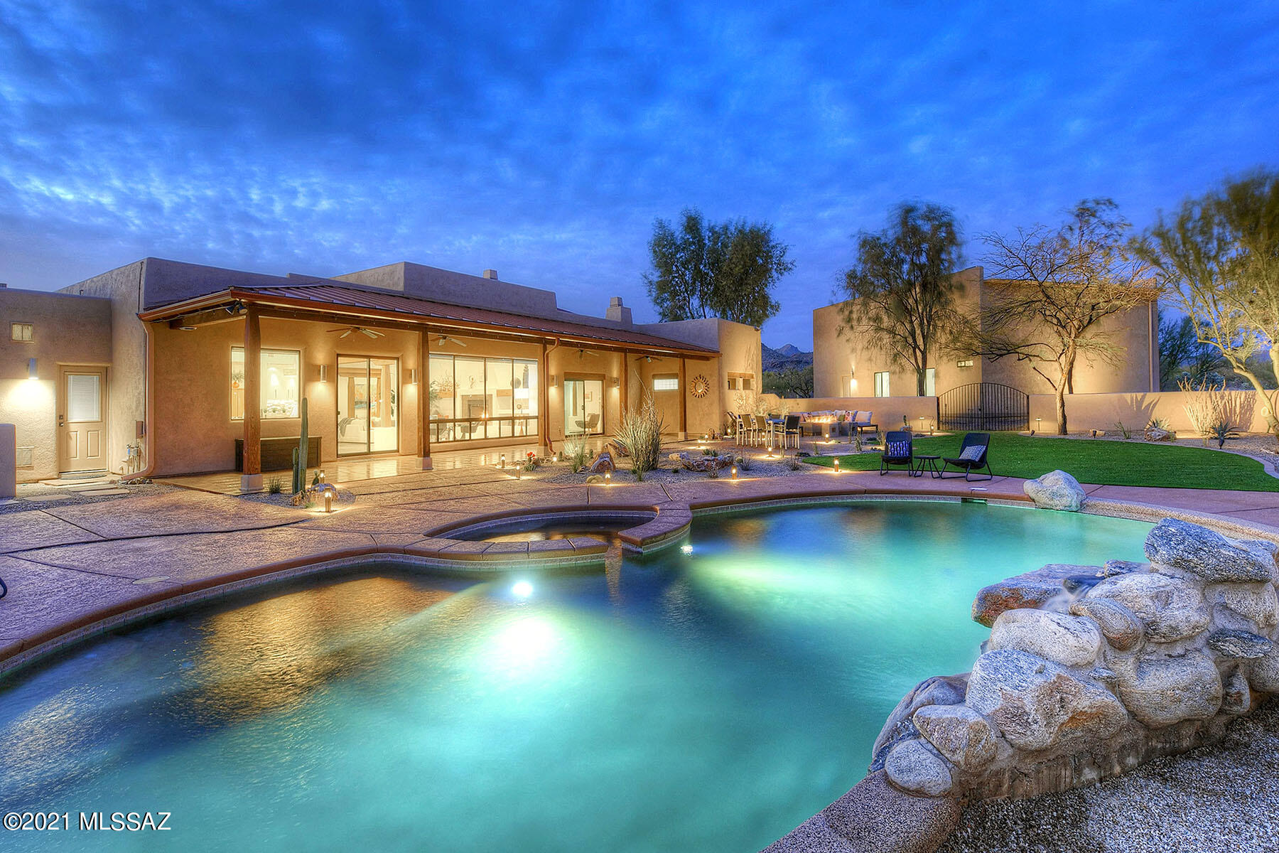 Sellers will accept or counter offers between $1,250,000 and $1,350,000. This stunningly remodeled Southwestern contemporary is nestled on a 4.26 acre view lot near Thornydale and Moore Rd. in a small private community of luxury homes. Nothing has been left untouched in this 4,840 sq. ft., 5 bedroom masterpiece that includes a 961 sq. ft. attached 3-car garage, a detached 4+ car garage/workshop, and an owned solar system. Enter into the grand great room with soaring 14' wood planked & beamed ceiling, a wall of windows framing Catalina Mountain views, and a contemporary-style fireplace. The fabulously remodeled gourmet kitchen provides designer stainless steel appliances, all new cabinetry/tile/lighting, a massive center island with quartz countertop that seats 6, soft-close drawers & cabinets, a butler bar prep sink, a gas cooktop with downdraft, a powder room off the kitchen, and a sliding glass door to the back patio & pool area. The graciously remodeled master offers a contemporary-style fireplace, a spacious walk-in closet by California Closets, dual vanities, a large jetted tub, an oversized shower with dual shower heads, and a sliding glass door onto the patio with Catalina Mountain views. All rooms are on the first floor with no steps; however, upstairs is a large office with walls of windows, Tortolita Mountain views, a bathroom with shower, and an observation deck. Enjoy the beautiful backyard featuring an expansive covered patio, a pool, a spa and mountain views. The detached garage and workshop boasts racetrack flooring, 30 amp 220 circuits, 50 amp RV outlet, full-shop air compressor plumbing, an RV garage door with a 16' ceiling, a tank-less water heater, dual heat pumps (heating & AC), and a bathroom with a shower. So much more and so little space in which to describe it, so see this wonderful home to appreciate it!