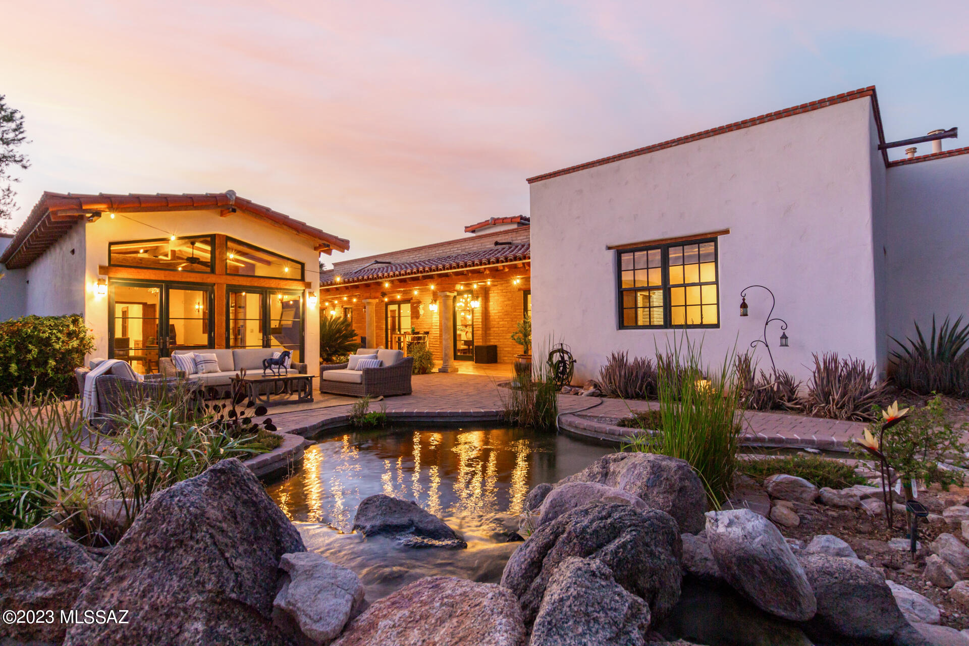 Step into this enchanting Mexican Colonial home built by celebrated home builder Stellar Gray and find yourself transported to a peaceful retreat from modern life. Every detail is intentional and exceptional. Scored concrete floors, hand-hewn exposed beams, custom Alder doors and cabinets, vaulted ceilings, Venetian plaster, and beautiful Talavera tilework are found throughout the property. Vintage Mexican gates open into a serene walled courtyard with a Koi pond that is ideal for entertaining. The kitchen features a Wolf stove and double oven, Bosch dishwasher, built-in microwave, prep sink, an under-sink reverse osmosis system, and custom tile. A 16.6kW solar system helps to power a level-2 electric vehicle charger in the 3-car garage contributing to additional energy savings. The private back patio features a pebble-tec lap pool with a lagoon, perfect for cooling off on warm days. Relax under the powered ramada, and enjoy using the Kokomo gas grill.

The outdoor area was featured on the 2018 Tucson Botanical Gardens tour. A variety of low-water plants abound, including jasmine, honeysuckle, trumpet vines, Russian sage, and a number of productive fruit trees. 

The casita has its own access and is heated/cooled by two mini-splits, one in the main room and one in the bedroom. 

Surround sound speakers can be found throughout the house, along with a fire suppression system, security video monitoring, and glass break alarm system. 

This is a one-of-a-kind property in central Tucson, close to the university, schools, downtown, parks, and shopping. Don't let this exquisite gem pass you by.