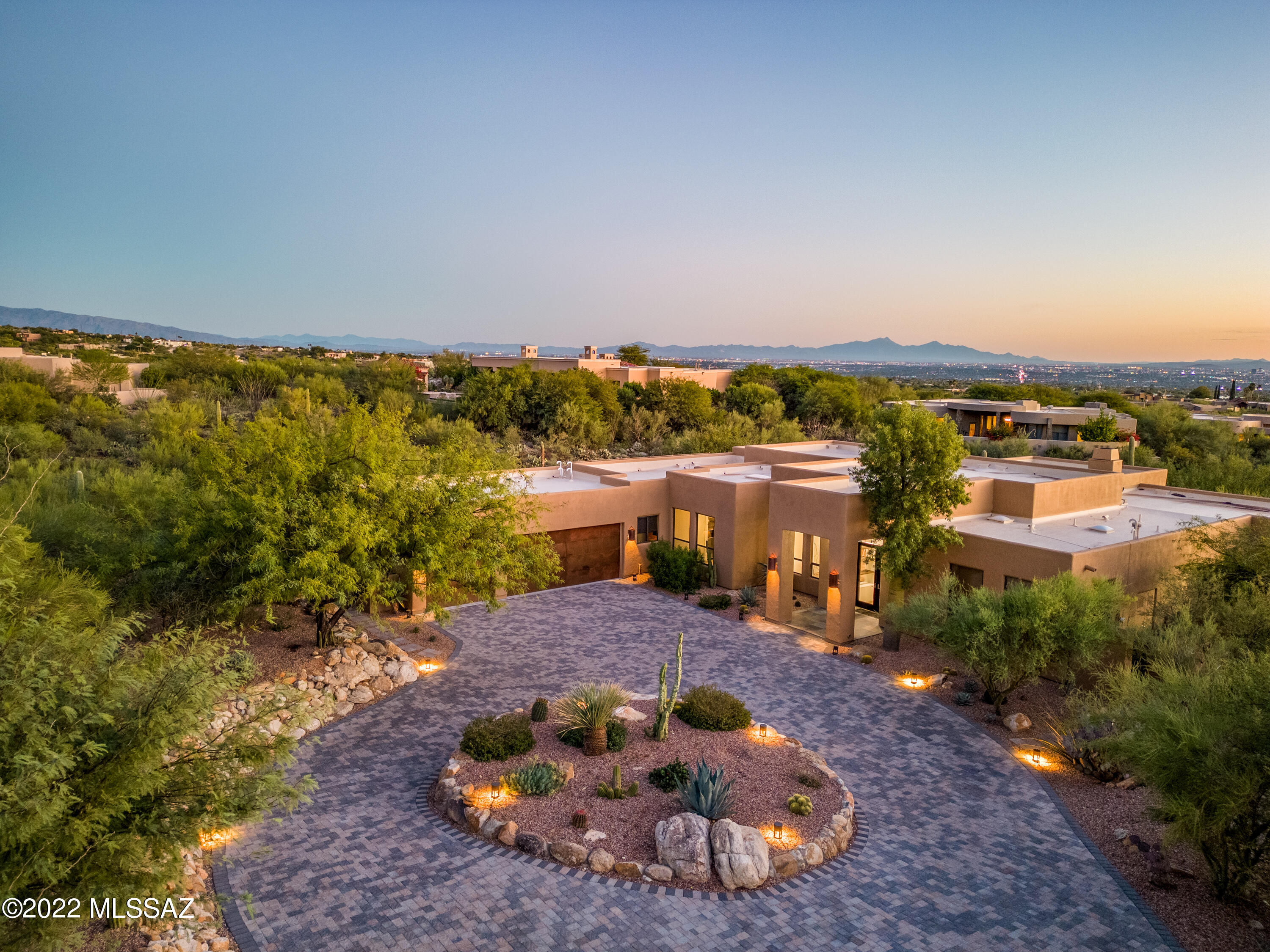 Tucked away in the prestigious guard gated Pima Canyon Estates, this four-bedroom home perfectly blends sophistication with a modern entertainer's paradise. Meticulously hand-crafted finishes, dramatic design choices, and abundant sunlight flow throughout the house, including the chef-approved kitchen with granite counters, stainless appliances, and a breakfast nook. Numerous recent updates adorn this truly spectacular property, perfectly intertwined, complete with a seamless indoor/outdoor gathering space. The natural Xeriscaped elements further maximize the privacy surrounding the property and pool deck. Amenities include an epoxy floor three-car garage, brick paver circular driveway, and easy access to all of Tucson!