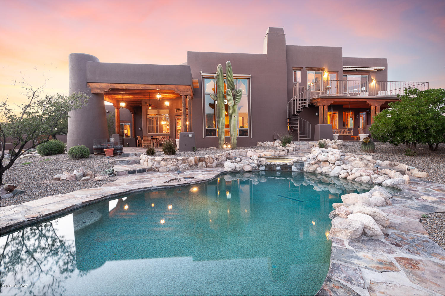 Privately gated one-owner custom home on a 5.21 acre lot on the north side of the Saguaro National Park East is an equestrian's dream come true. 5-stall barn w/tack rm, approx. 700 sf workshop w/ full bath & addt'l covered parking & 2 arenas w/ easy access to SNPE from Broadway Trail.  This home has never been on the market & it will not disappoint.  Enter thru custom gates on an exposed aggregate driveway w/ custom lighting with exquisite views of the Rincon Mtns to the east. Charming gated courtyard entry leads to entry & great room w/ 24 ft. ceilings, beautiful slate floors & dramatic slate FP. Great room is open to upgraded kitchen w/ island & breakfast bar, walk-in pantry, granite, custom cabinets & SS appliances. Lovely breakfast area off kitchen
& formal dining room. Upstairs find loft area w/FP, wet bar & 3/4 bath w/access to deck w/stunning mtn views.  Spacious mstr suite w/ FP & expansive mstr bath w/jetted tub, walk-in shower, dual vanities & tons of closet space. Split bdrm floor plan offers separate wing w/ 2 guest bdrms & full guest bath, large laundry room, powder rm for guest & office that could be 4th bdrm. Backyard has deep covered patio w/FP & outdoor dining area, pool, spa & wonderful year-round dog house w/dog doors. 3-car garage with tons of storage & extra space.