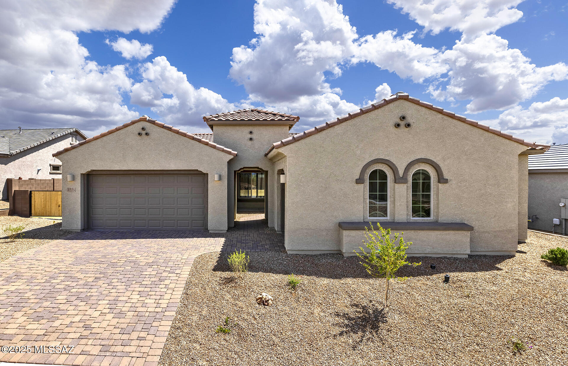 Available now.  Patagonia plan with spacious 5BR/3BA open concept. Landscaped front yard and breezeway with pavers in front courtyard.  Trey ceiling in gathering room with 4-panel sliding glass door. Glass French doors to den and huge island kitchen, whole-house, white quartz counter tops with WP gas stove, dishwasher, microwave and oven. White cabinets include trash/recycle bin and soft close, full overlay, upgraded drawer construction.  Bedroom 5 is private suite tucked away from other bedrooms. Glass low-threshold shower at owner's bath. Upgraded electrical features include surround sound pre-wire and ceiling fans and pendant lights installed at kitchen island. Energy Smart home includes radiant barrier and tankless water heater. Laundry sink is pre-plumbed, WP washer/dryer included.
