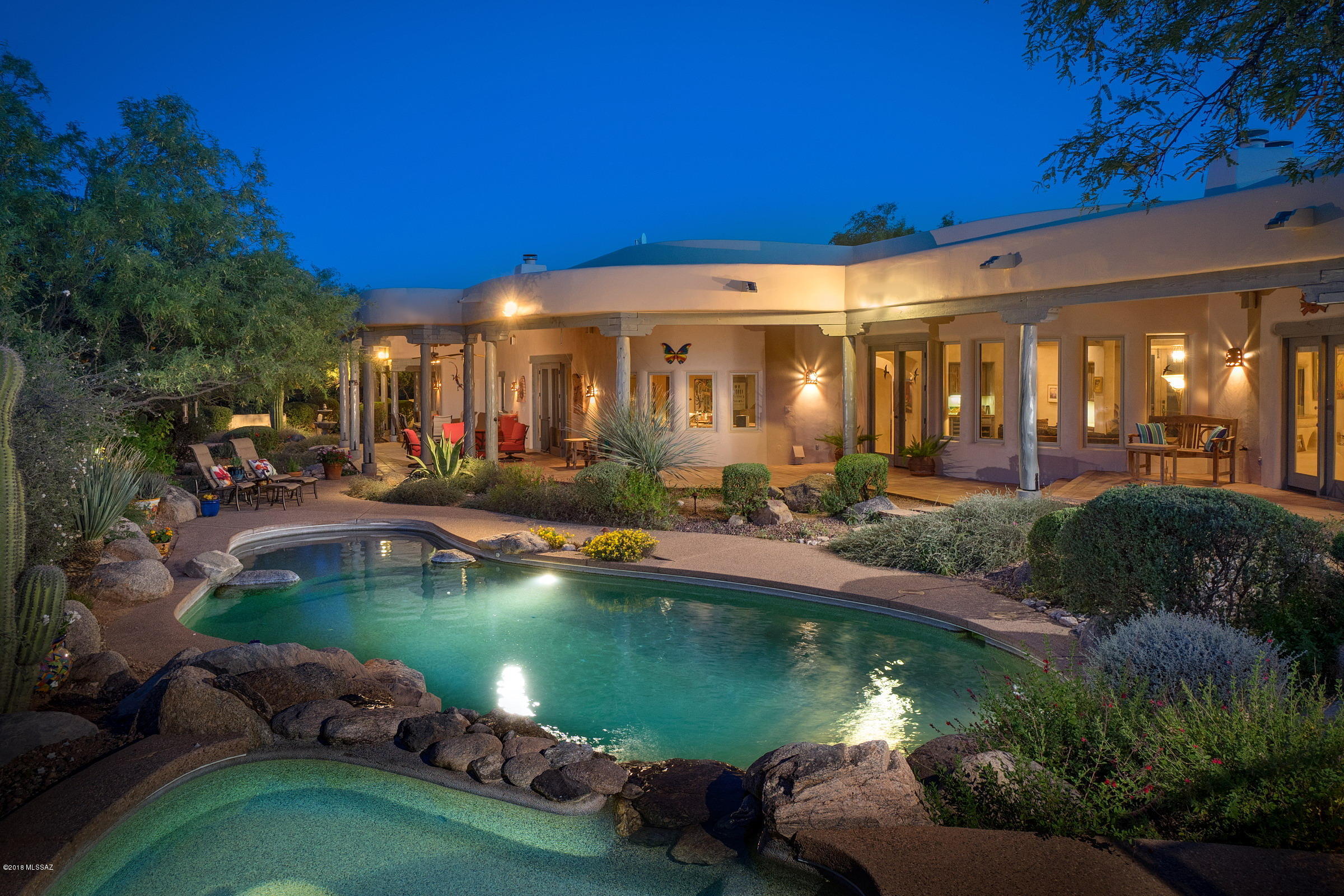 This Remarkable Upscale Home Exemplifies Classic Santa Fe Style w/Saltillo Tile Flooring, Classic Ceiling Finishes & Kiva Fireplaces. Constructed in 1999 by Ray Birch, known for his One-Of-A-Kind Santa Fe Dream Homes, who Prides Himself on Building ''Homes, Not Houses''. The Gourmet Kitchen Reflects the Builder's Design Touches w/Knotty Cedar & Saguaro-Rib Cabinets + Traditional Mexican-Style Tiled Countertops. Modern Touches include Subzero Refrigerator, 5-Burner Gas Cooktop, R.O., Large Walk-In Pantry & Insta-Hot Water. 5BR/4BA Split Bedroom Floor Plan w/2 Master Suites & 3-Car Garage. Located on 3.35 Acres at the Base of Mt Lemmon. Amazing Backyard Oasis w/Pebble-Tec Pool/Spa, Cascading Waterfall & BBQ. Extensive Wrap-A-Round Patios + Spectacular Mountain Views & Privacy.
