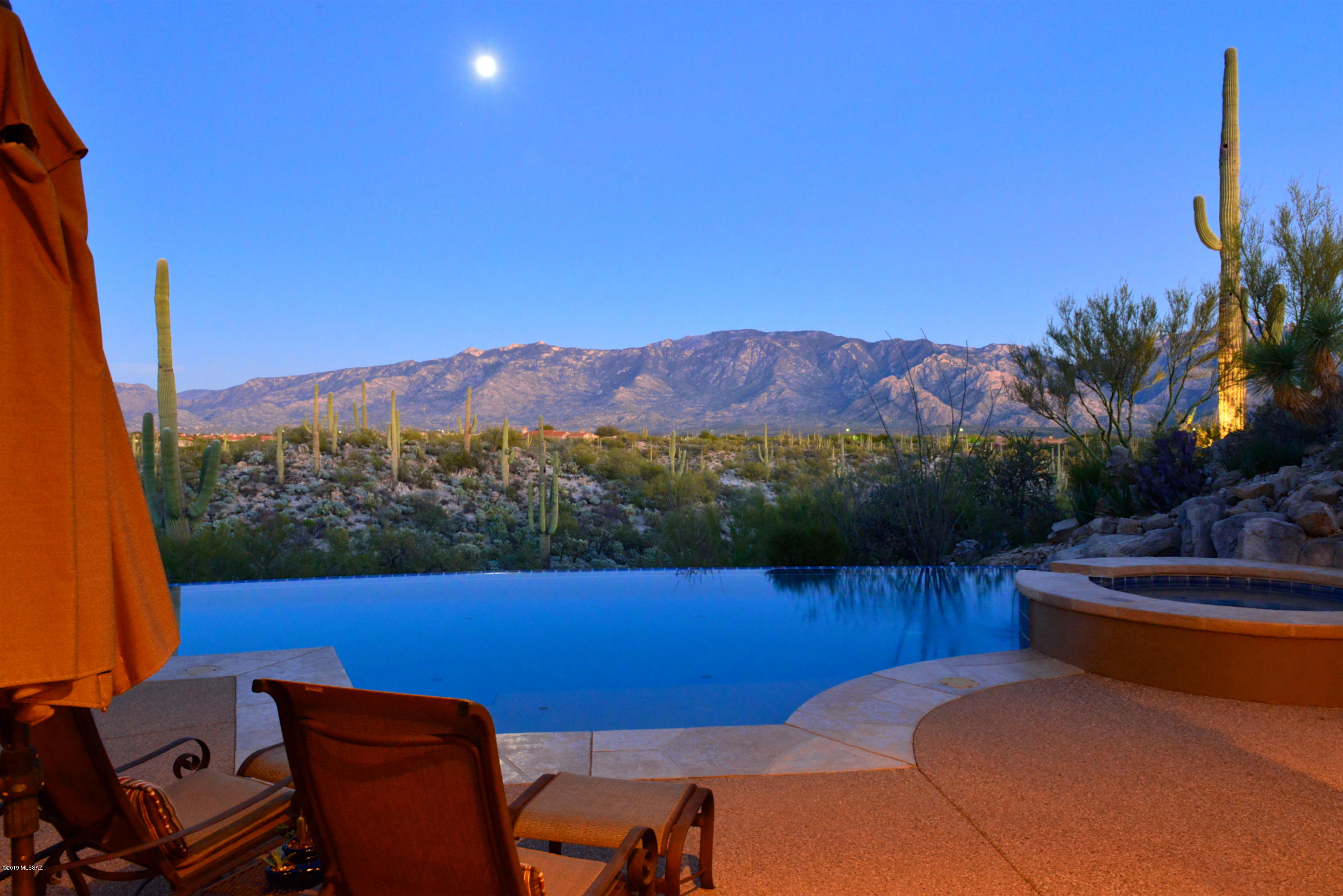 Exquisite custom residence with AWESOME east-facing Catalina Mtn views high above Honey Bee Canyon! Stately stone-faced columns grace the contemporary architecture of this single-level 4,426 SF residence in gated Honey Bee Canyon Estates. Walls of windows showcase majestic Catalina Mtn views across saguaro-studded Honey Bee Canyon. Timeless architecture by Ron Robinette with creative appointments by ASID designer Lori Carroll seamlessly meld stylish and comfortable design concepts to create a relaxation-oriented private retreat.  Amenities include: 3BR, Office or 4th BR, 5BA, formal living/dining, spacious family room kitchen (with Dacor, Asko & Sub-Zero appls, island bar & informal dining), sandstone floors, 3 Fireplaces, negative edge pool with spa, covered BBQ, 3-car garage. DAZZLING!