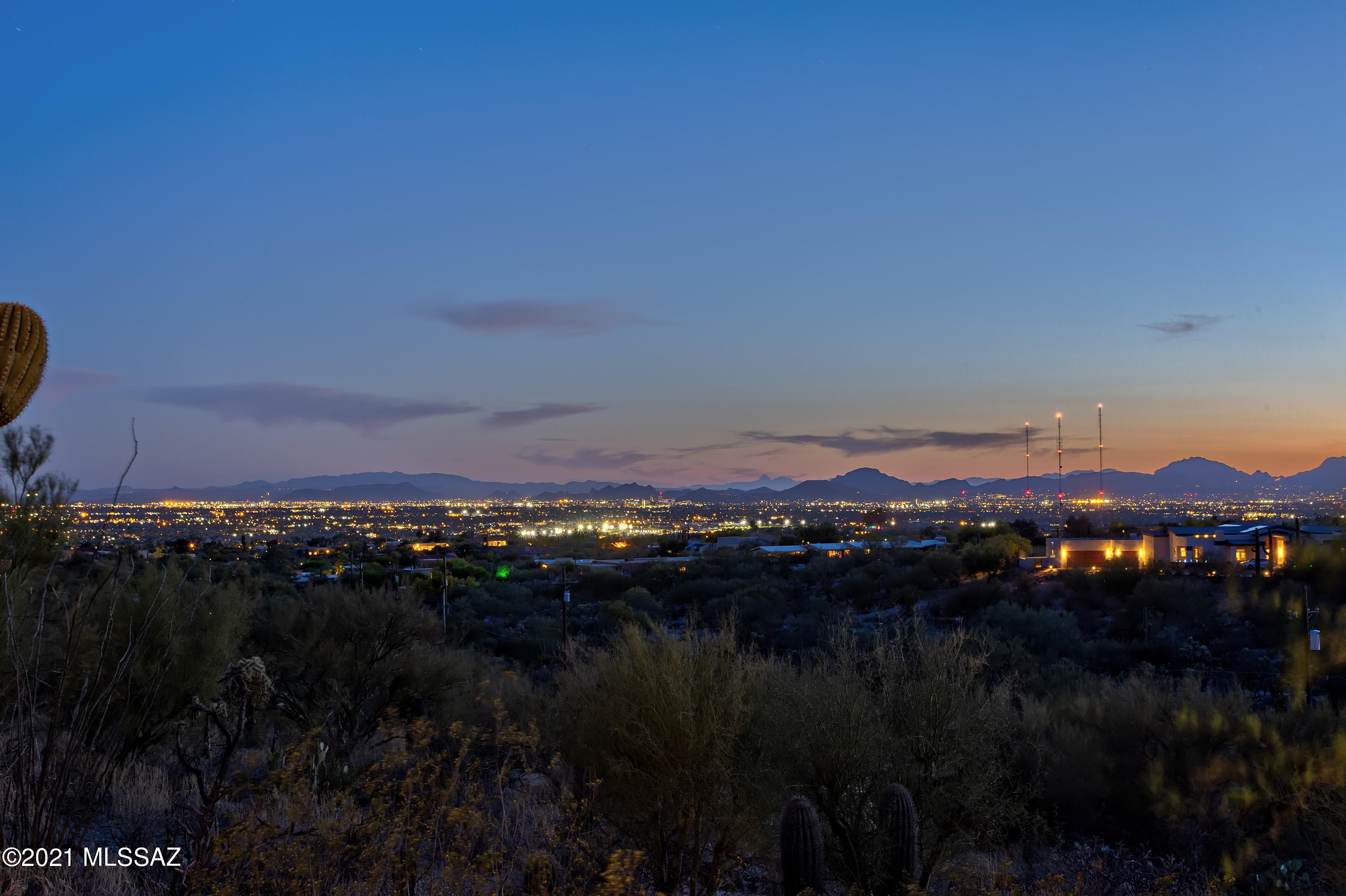 Unique, stunning and updated custom Howard Curtin designed estate.  Breathtaking mountain and city views due to the home being on the top of an elevated 2.63 acre lot. Updates and upgrades include; remodeled kitchen with custom cherry cabinets, high end granite and built-in appliances, Pella doors and windows throughout, Cumaru wood floors with 24x48 Vittorio Bianco Polished Porcelain Tile in master bedroom & common areas, fresh paint, recently replaced A/C with furnace, travertine tile in master bathroom with separate shower and dual vanity sinks and custom cabinets and granite counter tops in the laundry room, new toilets, cam lighting and outlets. The lot can potentially be split, buyer to confer with governing authority for opportunities. HOA fee of $65 a year is voluntary. Owner/Agent