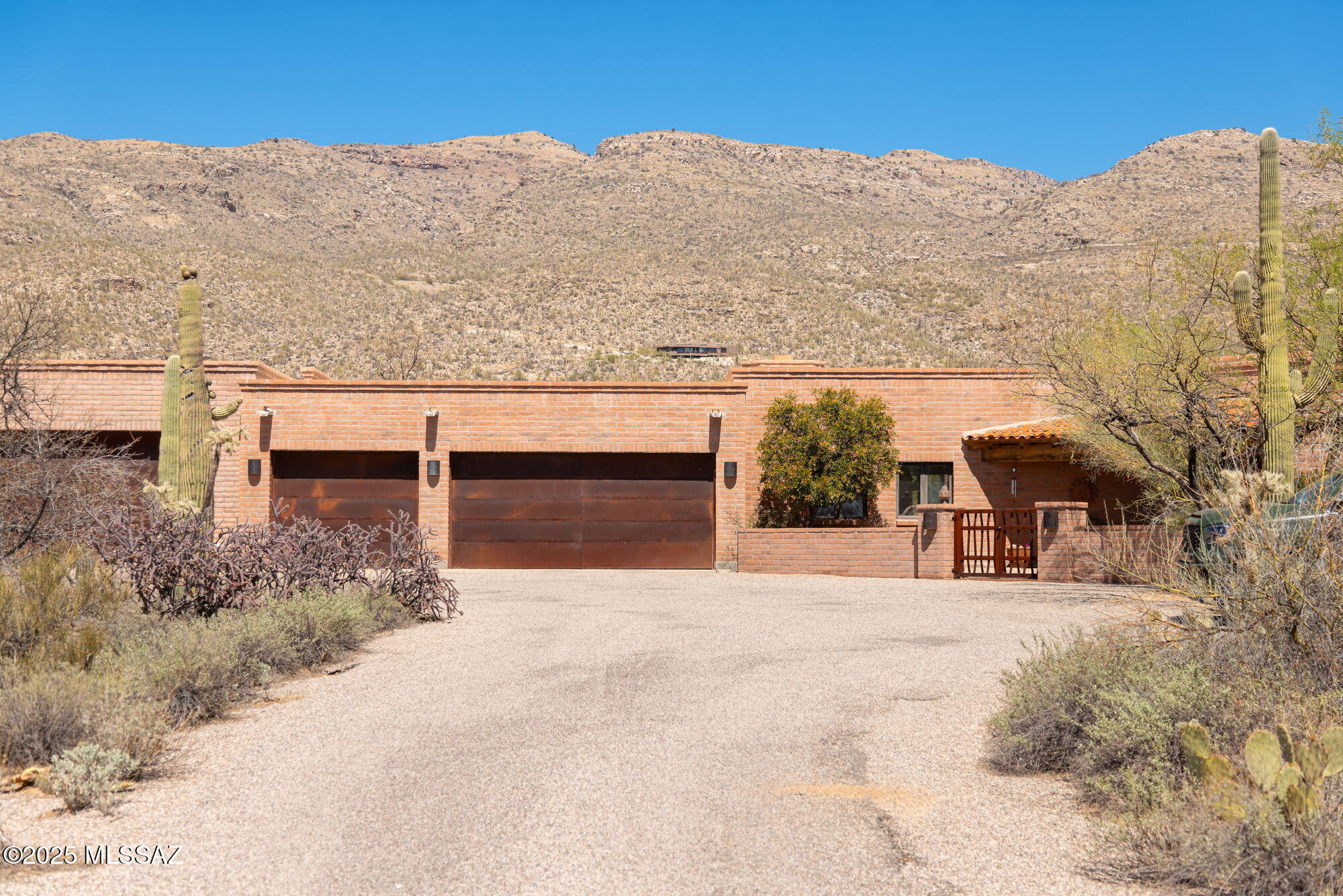Quality & Craftsmanship is evident throughout this Hacienda Style Masonry Custom Home. Ideally situated in the Tanque Verde Valley to capture panoramic views of Milagrosa Canyon. Layout features 4 bedrooms, 3.5 baths, 3,714 sf that perfectly blends Luxury & Comfort: Formal dining area, living room, & Family room off kitchen. The Chef's Kitchen has oversized hardwood island, high-end appliances, and top tier cabinetry.  Living areas effortlessly blend with resort like backyard: fireplace, pool/spa, half bath, and outdoor kitchen/bar. Grand Primary Suite, generously sized bedrooms, & Laundry room that doubles as Butler's pantry completes interior. Oversized 7 car garage has room for all the toys & hobbies.  Natural Desert surroundings allows for peaceful enjoyment both day & night.