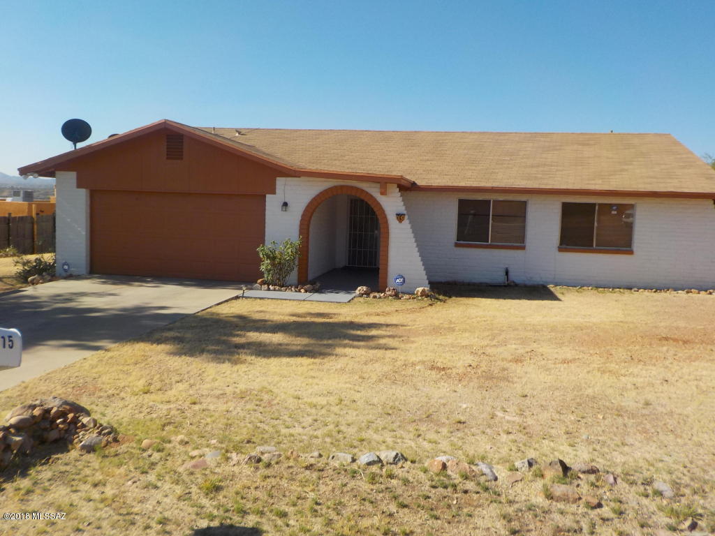 ORIGINAL PRICE WAS $155K.  JUST REDUCED, PRICED TO SELL! Enjoy a serene setting overlooking the nearby mountain ranges. This centrally located block construction home is near the Rio Rico Fitness Center. It offers many great features which include spacious bedrooms, fireplace, ceramic tile throughout, 2 full baths/2 half baths, a large rear yard, alarm system and more. Bring us your offers.