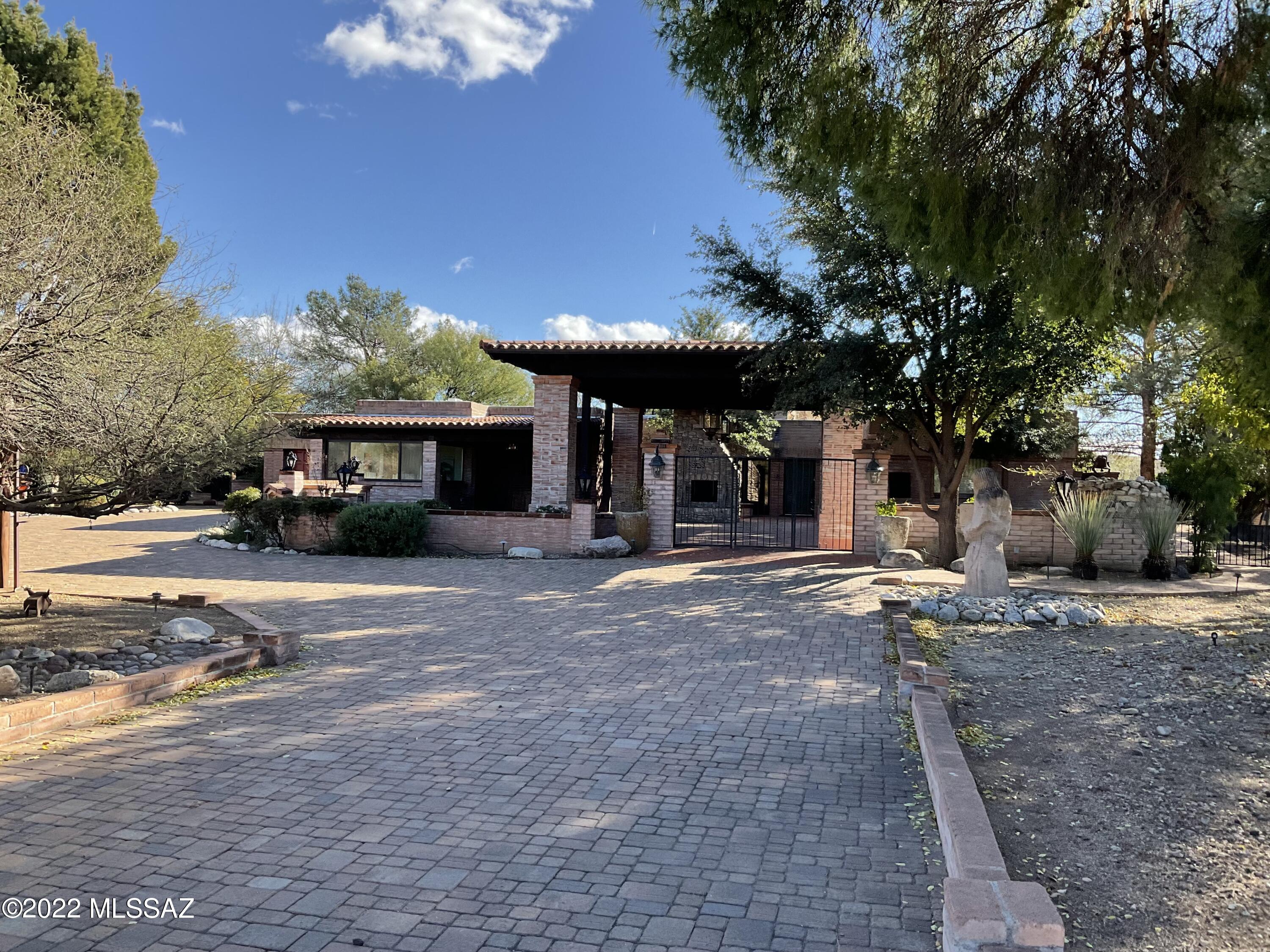 Located on a private road in the world-class Tubac Golf Resort and Spa, this beautifully renovated 3 bedroom, 3 1/2 bath home features a dramatic front covered patio with a striking rock fireplace. The living room with its dramatic soaring ceiling faces the 1st fairway, Otero course, setting the tone for this impressive home with custom cabinetry throughout. The well-planned kitchen with its spacious eating area opens to an inviting covered patio with gas BBQ. Low-care landscaping features dramatic water features & meandering paved paths within the private walled yard. There is an art studio with 3 walls of windows and a separate exterior entrance. The 3rd bedroom with a gas fireplace is used as the family room/office. There are no HOA OR CCR'S for this property.
