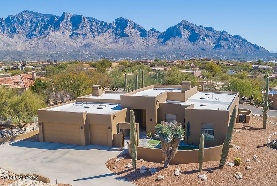 Striking 3BD/3BA+Den (2,842 sq ft) home on large corner lot boasts panoramic mountain views. Enter through a gated front courtyard to find formal & informal living spaces highlighted by 10-12' ceilings, walls of windows, plank flooring and contemporary lighting fixtures. Great room boasts a fireplace w/marble surround and sleek chef's kitchen with stainless appliances, island w/breakfast bar, and Cambria quartz countertops w/marble backsplash. Elegant Master suite hosts a walk-in closet and luxury bath with freestanding tub and glass-enclosed waterfall shower. Second/third bedrooms share hall bath. Large den/office plus powder room. Decorative turf with 24x24 inset pavers accent the rear yard & courtyard. Relax on the dual rear patios w/smooth limestone pavers while enjoying sunset views!