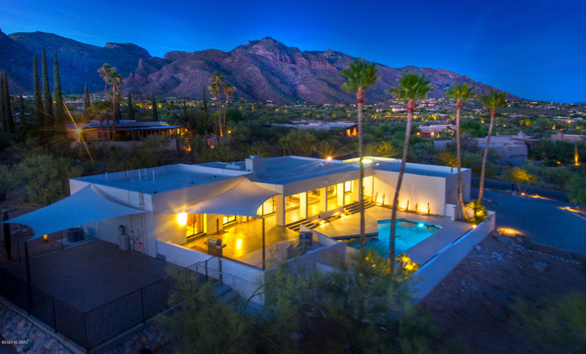 This immaculate 2,980 sqft chic contemporary home was designed by award-winning architect Bernard J. Friedman as his personal residence.  Nestled in the Catalina Foothills it enjoys panoramic city & mountain views. The inviting and zen-like outdoors features a south facing salt water pool, covered patio, high-grade shade sails, built-in kitchen, fire pit. Elevated aesthetics and material quality made this remarkable update and remodel happen. The modern indoors features: open floor plan, exposed wood beams, light grey floor, no carpet, floor to ceiling dual pane windows, ss appliances, granite, cooking island, perfect proportions, chic design, excellent flow and lots of natural light w/out direct rays.  This FULLY RENOVATED home is a superb architectural jewel and it is available now