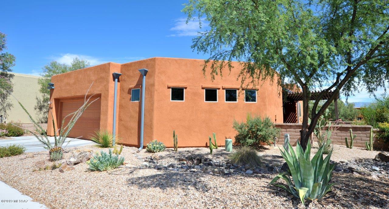 PRICED TO SELL at $9,000 BELOW the appraised value! This beautiful Civano home is situated on a double lot and offers 2 spacious bedrooms, 2 full bathrooms plus a den! The kitchen has an open concept with granite countertops and breakfast bar with pendent lighting. Master Suite has a tiled walk-in shower and a large walk-in closet. You'll fall in love with the backyard featuring 1,000+ gallon water harvesting tank, multiple garden beds, natural desert landscaping, pomegranate and fig trees, and a brick paver patio with a ramada. This energy efficient home includes a large OWNED solar system through SolarCity, tankless water heater, water filtration system and a 2-car garage with heating and cooling! Come make this house your new home!
