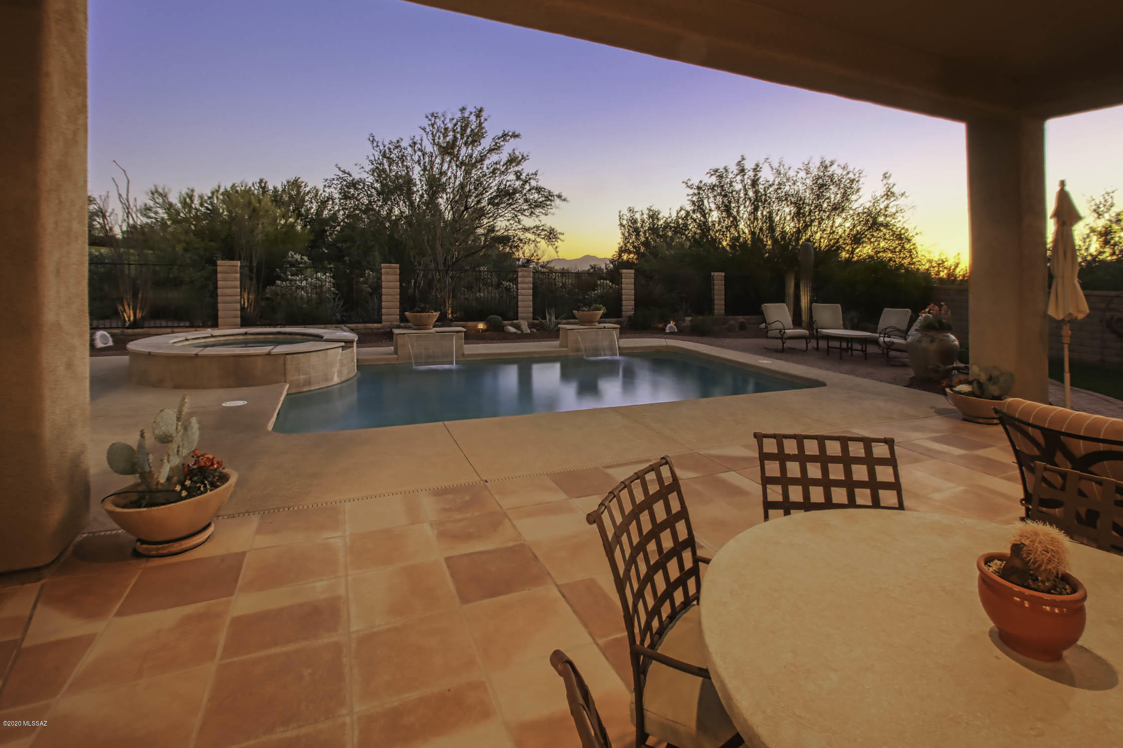 Exquisite home on The Gallery golf course. This popular floor plan in gated Dos Lagos at Dove Mtn is timelessly appointed from travertine flooring to the Cantera stone FP in the Great Room. A chef's dream kitchen with ample granite countertops, 5 burner gas cooktop & stainless appliances including a warming drawer. Great room has built-in entertainment center and wet bar. Large Master bedroom with bay window sitting area & access to backyard. Master Bath feels like a spa with large soaking tub and glass block shower. Enjoy the AZ outdoors in the resort-like backyard that backs up to the golf course & has a built-in BBQ, refreshing pool, in-ground spa, covered patio and of course the beautiful sunsets we are famous for.