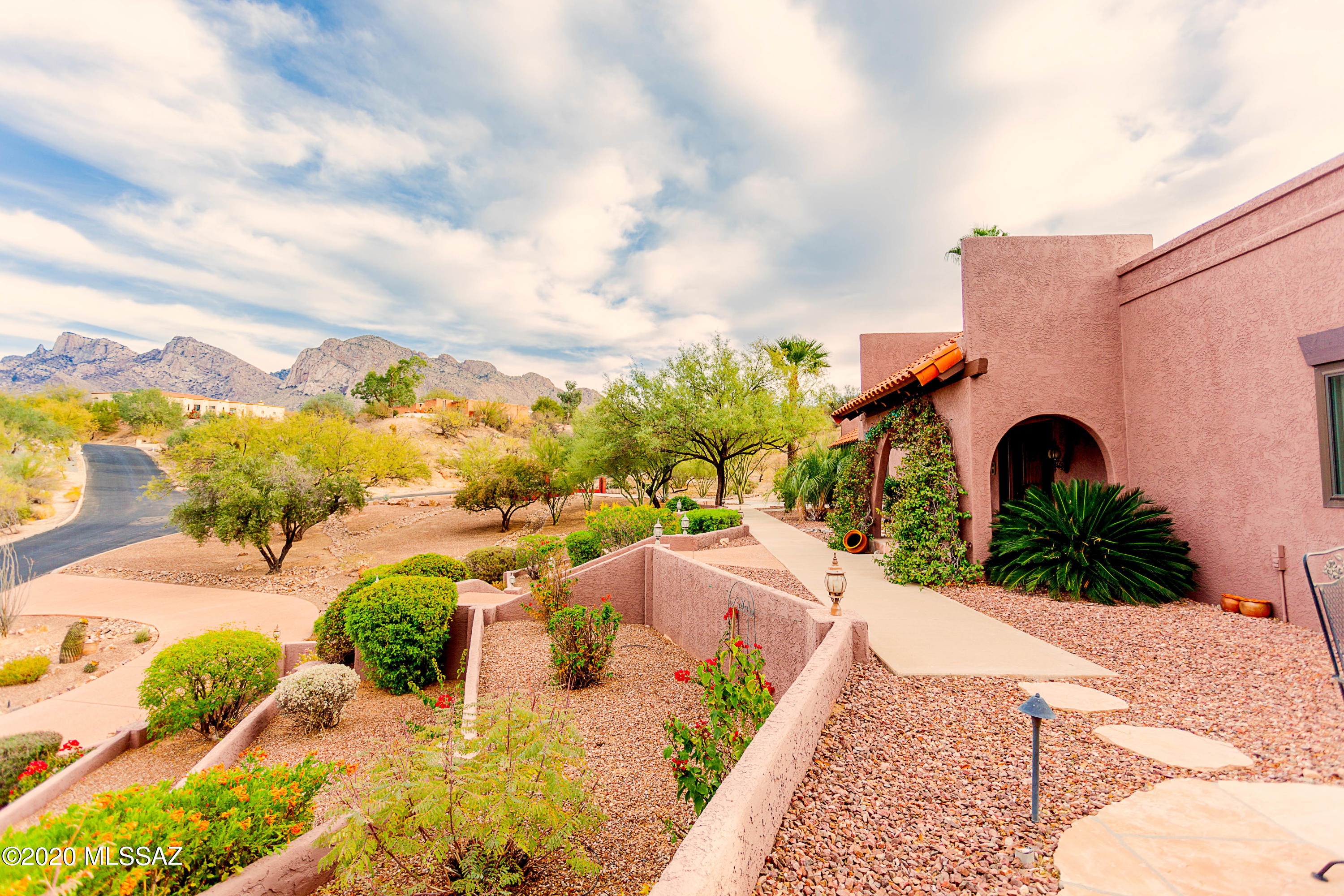 This elegant home has been totally and tastefully modernized, renovated, and move in ready!  Sitting on a hill in the heart of Oro Valley CC this resort style property offers breathtaking views of Pusch Ridge & Golf Course.  This single story home w/easy access from gar driveway boasts fully finished basement offering a possible in-home theatre, gym, rec room or office.  State of the Art surveillance system provides remote access from 6 cameras out and 2 in and alarm providing quick emergency response. The Audio Visual Sound System is second to none! An entertainer's dream w/14 speakers throughout home and on the over 900sqft of covered patio w/outside kit, 3 seating areas, fplc and remote controlled sun screens.  Rock wall on N side of home is over 60ft long, 14ft high and built to expand ...the yard, add security & access from Mstr Bdrm to yard and architecturally designed, along w/Grill Pavilion, to keep the arches consistent on all four entry points of home.