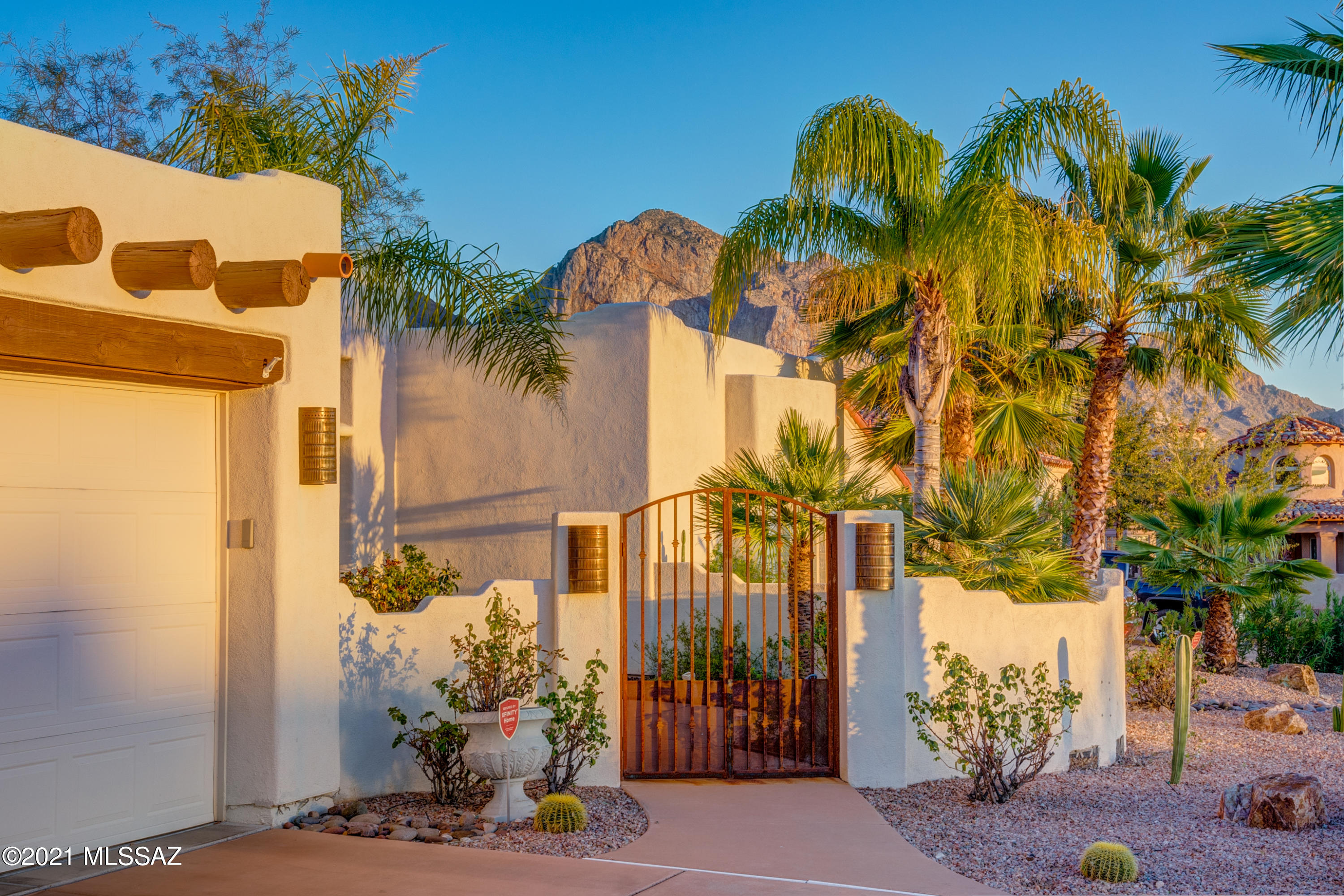 ABSOLUTELY STUNNING VIEWS OF PUSCH RIDGE! Your private oasis awaits at the end of this gated subdivision.  Over 3400 sq ft of living space captures the gorgeous desert surroundings at every turn. Spacious kitchen has perfect work space with ample cupboards w/roll-out drawers granite countertops, gas cooktop, double ovens and nice-size pantry. Kitchen overlooks the living space w/fireplace. Additional living area offered in the den/study. The master suite has a cozy fireplace w/access to backyard. The master bath offers two vanities, large tub, separate shower and two closets. The backyard is a glorious extension of the living space and will become your private sanctuary as you relax in the pool, grill at the built-in BBQ or sit by the firepit. Oro Valley living at it's finest...for sure