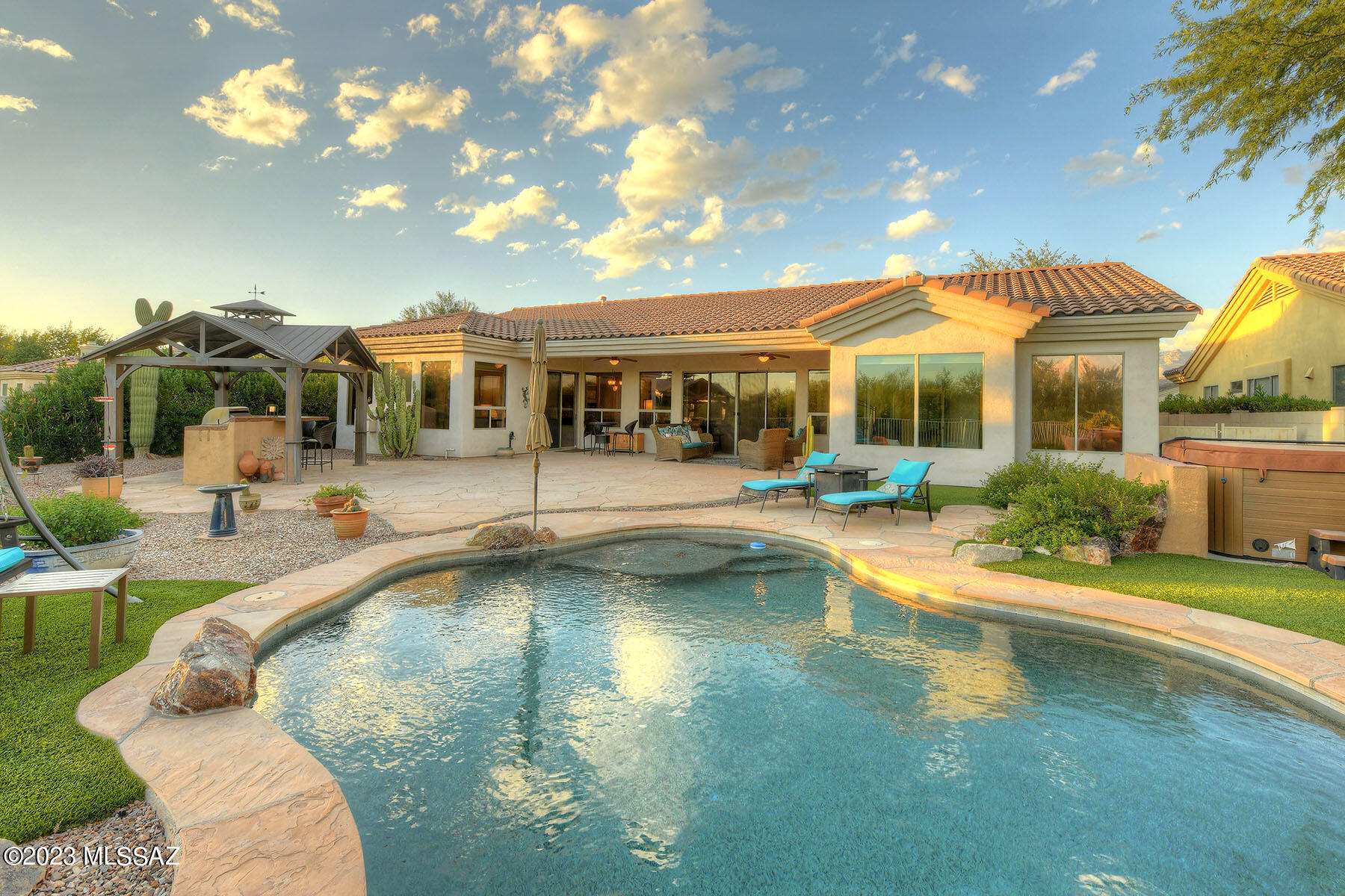 Total Privacy in Lakes at Castle Rock! Spacious 4-bed, 3-bath stunner offers 2736 sq ft of pure comfort. Desert oasis sits on .25 of acre is ideal for indoor/outdoor living with modern conveniences. Remodeled home features open living & split floor plan, new tile floors throughout & new window coverings. Large kitchen w/ss appliances, granite counters & lots of storage. Large living areas w/stone fireplace ideal for entertaining. Resort-Style backyard complete w/sparkling pool, hot tub, new outdoor grill/kitchen, cov'd patio, gazebo & lot backs tranquil wash w/gorgeous mountain views! Upgrades include, updated fixtures, ceiling fans & fresh interior paint, automated HVAC & smart Schlage home entry, new sewer line & drip irrigation system all make life easier. Peaceful Tanque Verde Valley. Almost all furnishings and furniture available on separate bill of sale. Making this a true turnkey property.
The Lakes at Castle Rock is a community like no other! This gated community offers it all: exercise facilities, serene lakes, scenic walking trails, a basketball court, a sparkling pool and spa, plus tennis courts. Live the resort lifestyle you deserve!
Recent Upgrades Include:
1.     Removed carpeting and tiled all striped areas (steam cleaned all original tiling)
2.     Repainted entire interior of home
3.     All window blinds refurbished and cleaned
4.     Upgraded ceiling fans in family room, master bedroom and formal dining/living area
5.     Restyled walk-in closet in master bedroom
6.     Added home automation (eco heating/cooling system with remote sensing, automated home entry Schlage system)
7.     Replaced all smoke alarms, upgraded to fire/CO sensors, and got them hard-wired
8.     Replaced broken garbage disposal unit
9.     Added fire door between garage and house
10.  Replaced damaged insect window and door screens
11.  Tree trimming and stump removal; removed broken fountain
12.  Installed a new drip irrigation system for front and back yards
13.  Completely cleaned hot tub and pool, replenished water in both by emptying and refilling with fresh water. Weekly service undertaken.
14.  Removed old outdoor grill and replaced with a bespoke, new grill designed to fit the current outdoor living space
15.  Removed old curtains from covered patio area
16.  Replaced old sewer line from house to street and added additional hardscaping to front yard
17.  Roof repairs undertaken to replace broken tiles
18.  Upgraded broken/outdated fittings and fixtures
19.  Replaced pool light
20.  Repaired water-damaged door frame in garage