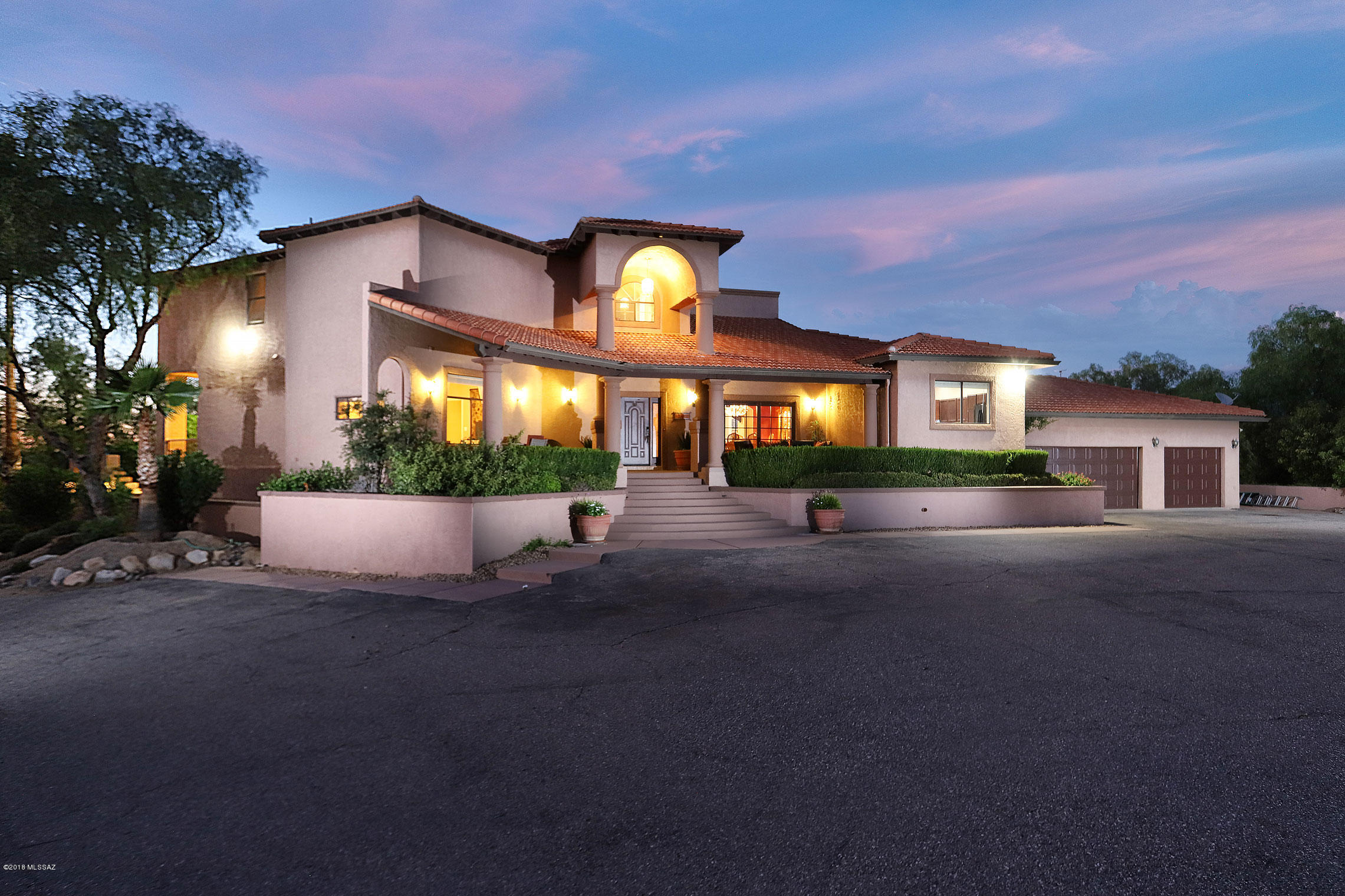 This Luxury executive resort style estate 4 bedroom, 5 bath, 5673s-f home sits on 2.17 acres with over 7600s-f of covered living space you have spectacular views of the Mountain ranges and city lights and only minutes from I-10. This unique Contemporary style architecture home was designed for luxury and comfort.  It offers a master gourmet kitchen with high end stainless steel appliances, imported Marble flooring, formal dining room, large walk in pantry, great room with fireplace, office/den, large 3 car garage with lots of storage. Once outside you have the wonderful 15x32 pool, and jacuzzi.  The pool has an electric pool cover, there is your built in grill with flagstone counters, refrig, and sink with an outdoor fireplace.  The yard is fully enclosed and beautifully landscaped.