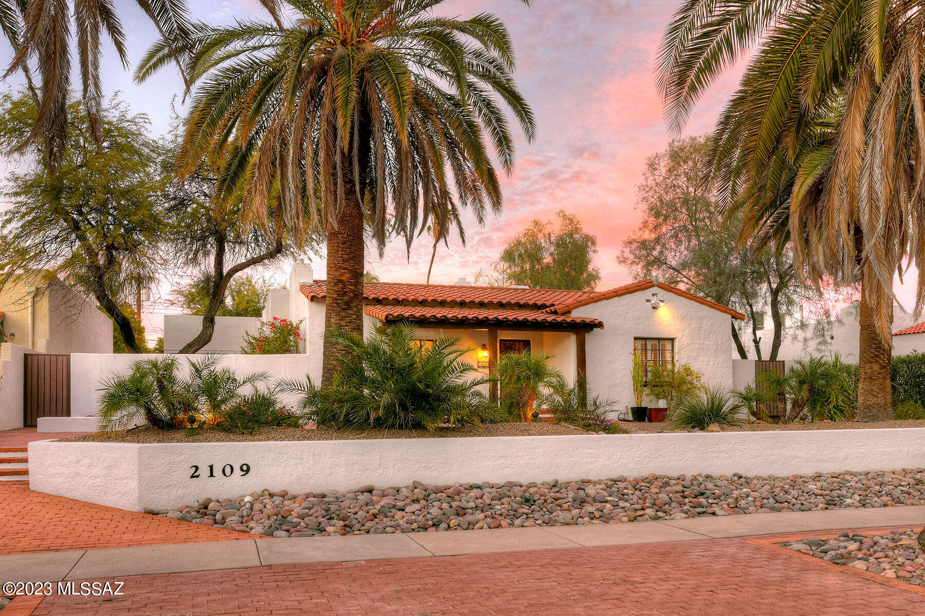 Spanish Mission 1929 home in Sam Hughes offers a blend of historic charm and modern amenities creating a comfortable residence. This property is a charming Spanish Mission-style home built in 1929, located in the heart of Sam Hughes. Here are the key features of the property: This home is a spacious, 2535 square feet.  It Offers 3 bedrooms and 3 bathrooms. The master bedroom is large and has a private patio, along with a newer en-suite bathroom. There are two other large bedrooms which share a completely remodeled bathroom with a deep claw foot bathtub. High ceilings in the living room and separate family room with 10' beamed ceilings, Living room fireplace, and hardwood floors, cozy and elegant.  The kitchen has been remodeled with newer Thomasville cabinetry and Dekton countertops. There's an eat-in area and an outdoor patio connected to the kitchen, providing a nice space for dining and relaxation.
The separate, large family room offers wood plank & beamed ceilings. The house features a formal dining room with butler's pantries, adding to the classic charm of the property. The property boasts a huge walled, relandscaped backyard, It features a newer pebble tech pool, Belgarde brick patios, creating a perfect outdoor oasis.  2 on-demand water heaters, upgraded plumbing, lighting fixtures, doors, windows, and electrical systems. There's also off-street parking available. This home is on the National Historic Register and eligible for a reduction in taxes for owner occupants.  Off street parking!
Walking distance to UArizona, Modern Street Car, Restaurants, parks and more!