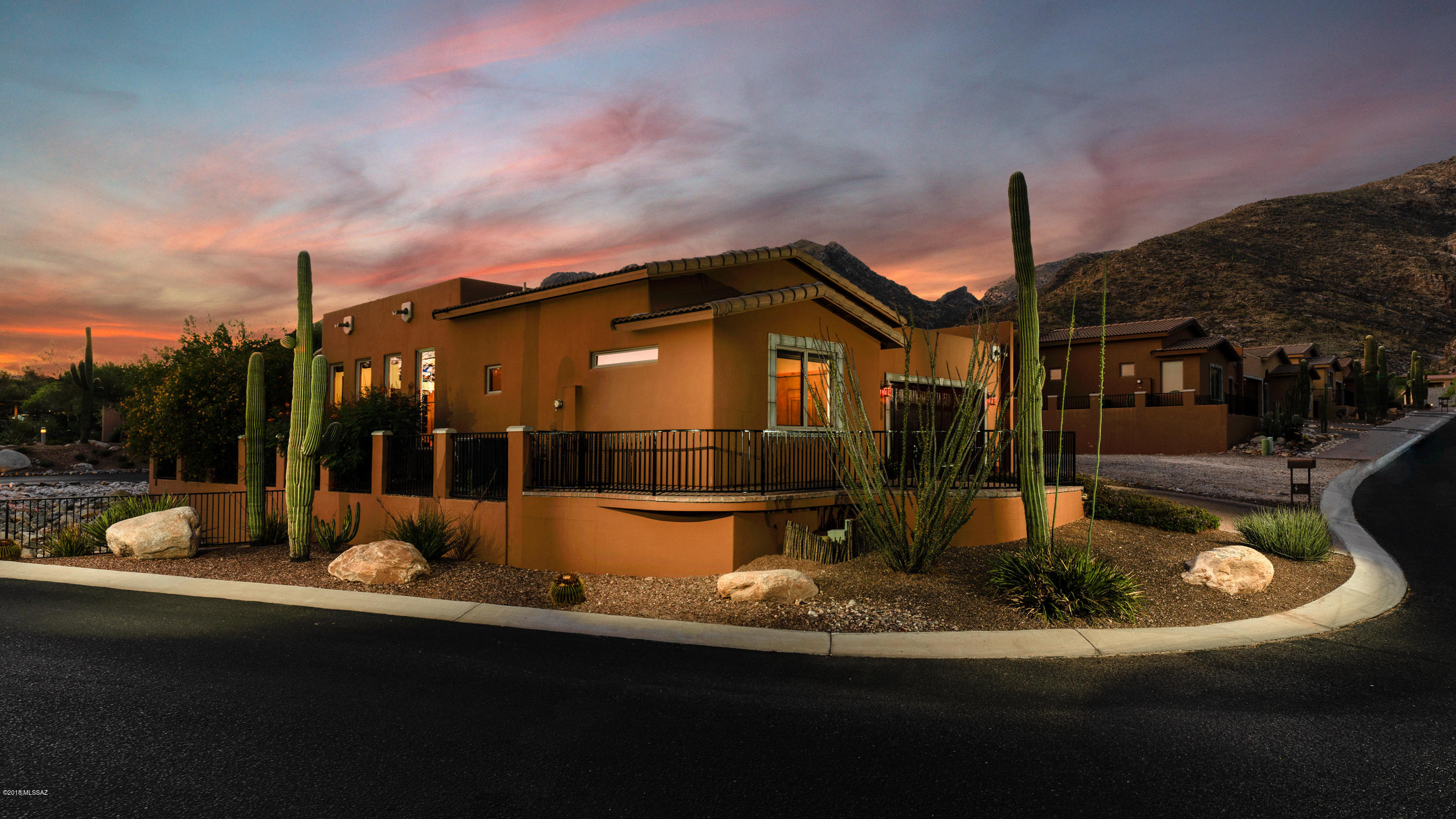 This elegant townhome is designed to exceed expectations in the coveted Sin Vacas community. 24 Hour manned security gate with stunning mountain, desert and city views. Single story 2 bed, 2.5 bath home with vaulted ceilings in the great room, alder wood cabinets and doors throughout. Travertine tile floors, granite counter tops, and top of the line GE Profile appliances. Split bedroom plan with two master suites and oversized walk-in closets. New A/C unit and water filtration system installed in 2017. Enjoy the beauty of the Catalina Mountains on this corner lot with a cozy front patio and an oversized rear patio for ultimate relaxation. Located directly across from the community pool. This is not a house you want, but a home you have been searching for. Don't Delay!