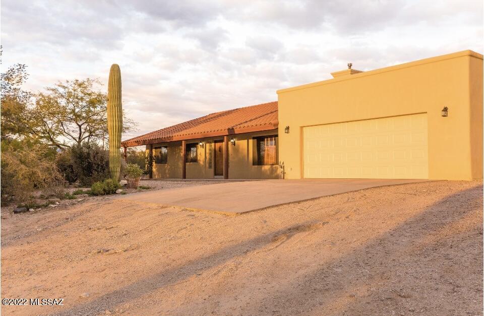 Range priced $760,000-$770,000.  
See drone video for exterior of property and horse facilities. 

This gorgeous ranch on 4 acres is nestled in the heart of the desert with amazing mountain views!  The welcoming and freshly paint interior spaces throughout the home are perfect for gatherings and entertaining.  The kitchen features Mountain Views from the kitchen sink and new appliances!  Guest quarters include two private entrances, open living area, bedroom and bathroom with walk in closet.  
The horse facilities are complete with lighted arena, tack room and plenty of space for additional livestock. After a long day at the ranch, relax on the front porch with a beautiful Arizona sunset.  Just minutes from Saguaro National Park, hiking and horse trails.
