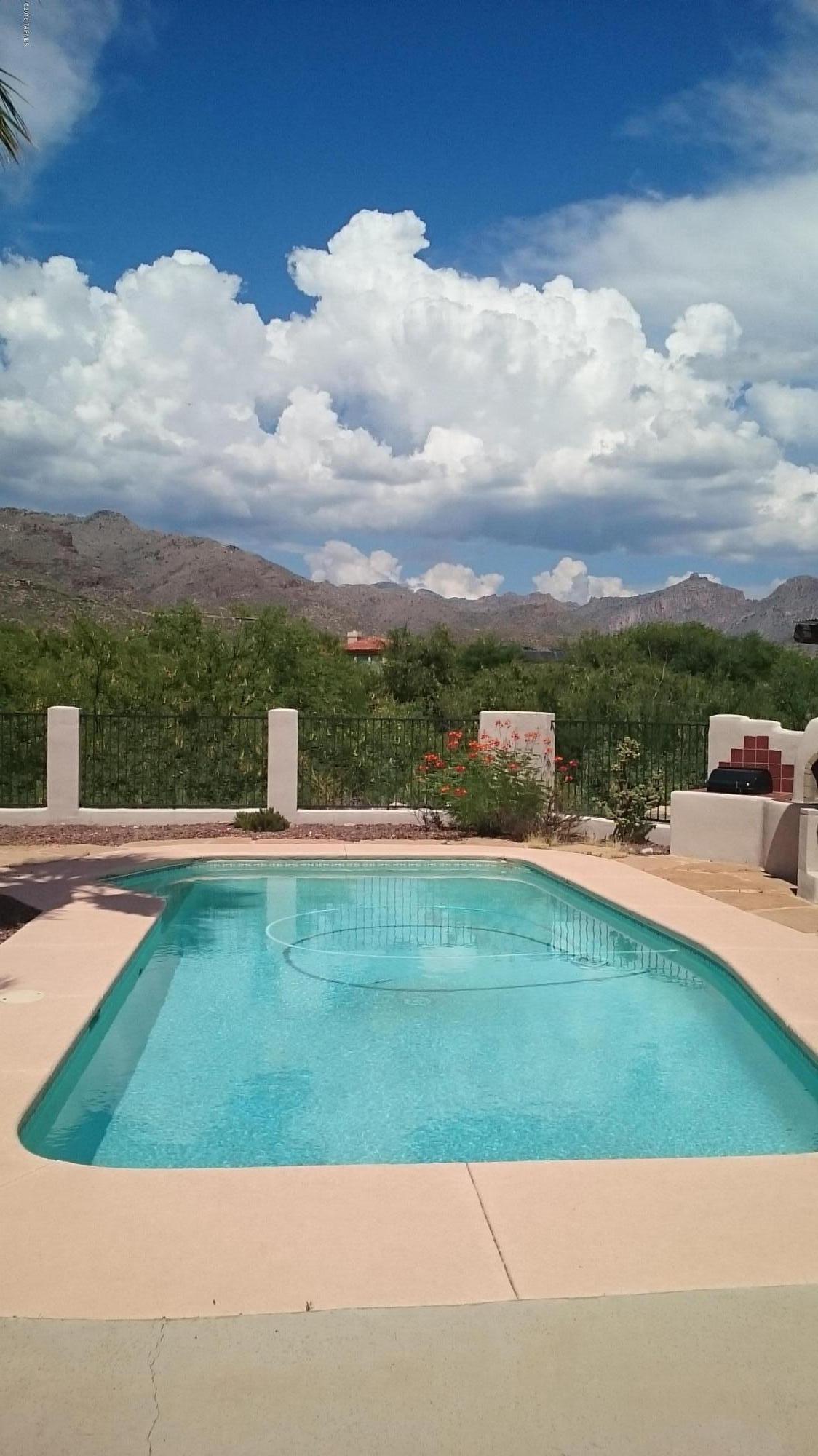 $137,000 PRICE REDUCTION!!!!!!
CUSTOM SANTA FE HOME ON PRIVATE 2+ ACRE LOT NESTLED IN SOUGHT AFTER VENTANA CANYON COUNTRY CLUB AND BACKS TO A LUSH ARROYO AND THAN TO THE 9TH FAIRWAY OF THE GOLF COURSE. INCREDIBLE MOUNTAIN AND LUSH DESERT VIEWS FROM SEVERAL $137,000 PRICE REDUCTION!!!!!EXPANSIVE COVERED PATIOS, FOR WIDE OPEN GORGEOUS VIEWS. THIS MAGNIFICENT HOME FEATURES SPLIT BEDROOM FLOOR PLAN, 2 COZY FIREPLACES, CENTRAL VACUUM, ALARM, SPARKLING POOL WITH RAMADA AREA, AND A 2 ROOM GUEST HOUSE. GRACIOUS MAIN SUITE FEATURES LARGE WALK IN CLOSET, EN SUITE WITH DUAL VANITY AND LUXURIOUS SPA. MOVE IN READY, COME AND ENJOY SPECTACULAR SUNSETS AND SWEEPING VIEWS FROM THIS CONVENIENTLY CLOSE TO EVERYTHING HOME TODAY!