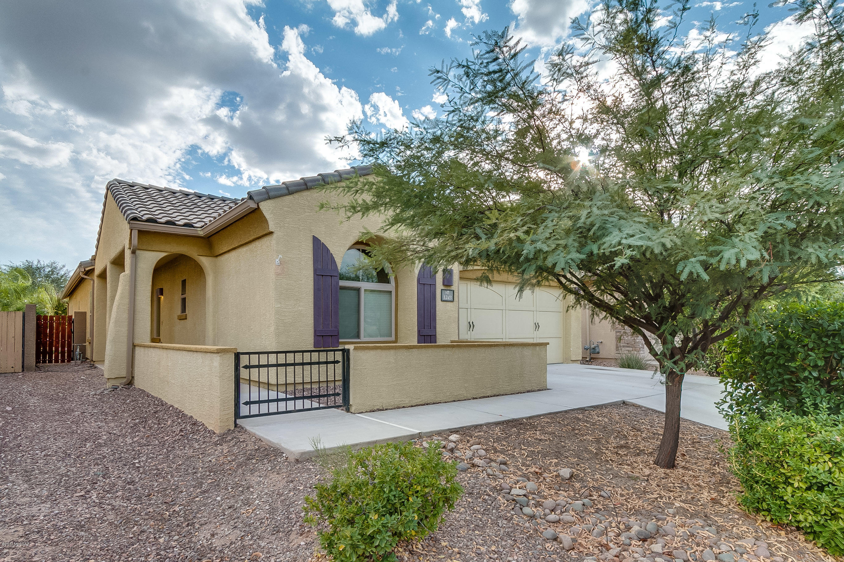 Spectacular 4BD/2BA + den (2,145sf) home  located in the desirable community of Rancho Vistoso. Enter this home and you will find a large great room with gas fireplace and access to patio. Open floor plan with split bedrooms for modern living. Open concept chef's kitchen with SS appliances, granite slab counters, and breakfast bar. Spacious master suite with bay window and luxurious bath w/dual vanities, garden tub, walk in shower and huge closet.  18 inch- tile throughout the entire home, no carpet! Outdoor living at it's finest! Backyard is private with covered patio, ramada, landscaping, fire pit, gas BBQ stub and Hot tub. Control hot tub right from your cell phone!