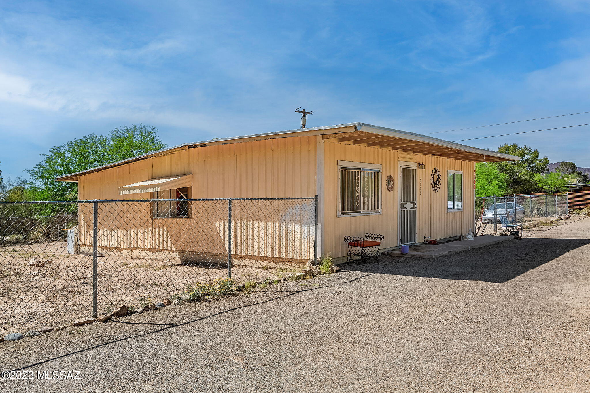Located in beautiful scenic Southwest Tucson, this charming home is so ideal for first a time homeowner or as an investment opportunity It counts with a bit over 0.30 acres of land and already fenced. This home features 2 spacious bedrooms, and attached bonus room and ample storage area. There is no HOA,  Room for RV and plenty of space for entertaining! Bonus room is not included in assessor sq ft. Home needs cosmetic update-HOME SOLD AS IS