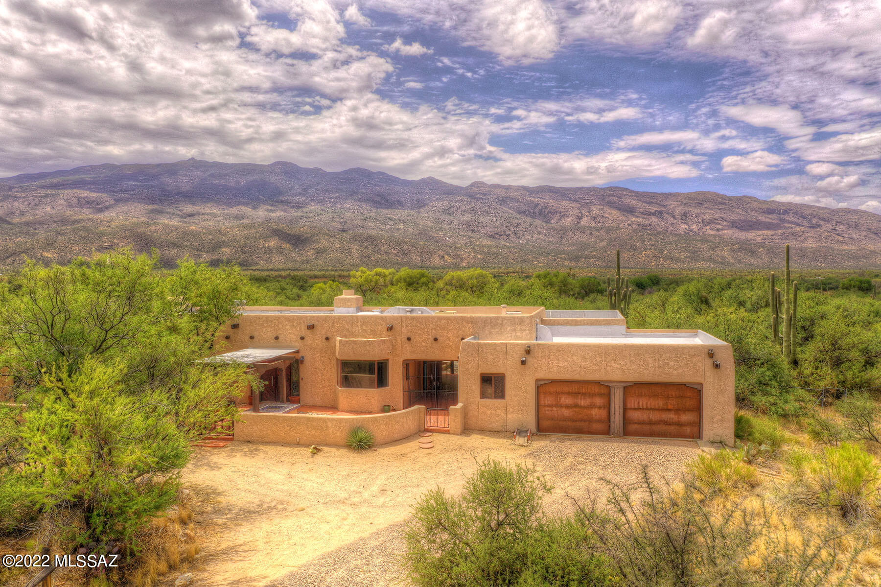 This home has stunning panoramic views in La Cebadilla Estates. Includes guest quarters with 1 bedroom 1 bath, living area and kitchenette. Main home is 3,286 square feet with 2 bedrooms plus a den and 2 bathrooms. Gorgeous living room has wood beamed ceilings, saltillo tile flooring and wood burning fireplace and is open to dining room with unique pizza oven. Cozy breakfast nook off the kitchen features wet bar and window seating. Enclosed Arizona room with fireplace has sliding glass doors to backyard with sparkling pool, extensive covered patio and magnificent views. 2 New AC Units,  brand new electric line to pool pump & sewer line re-piped with new clean outs installed. Property is 9.48 acres, backs up to the wash and is zoned for horses.